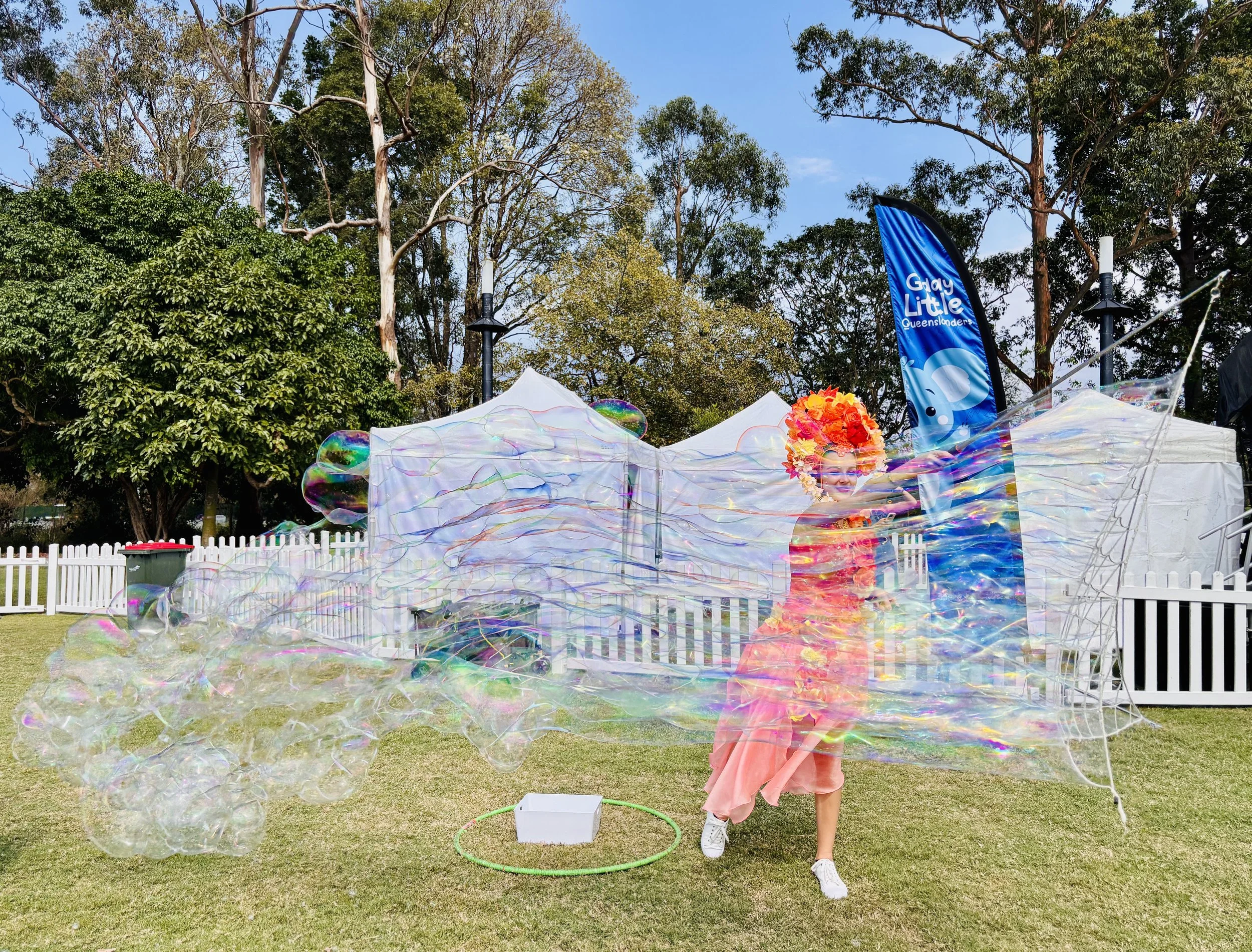 Giant bubbles floating above crowd at family event in Brisbane