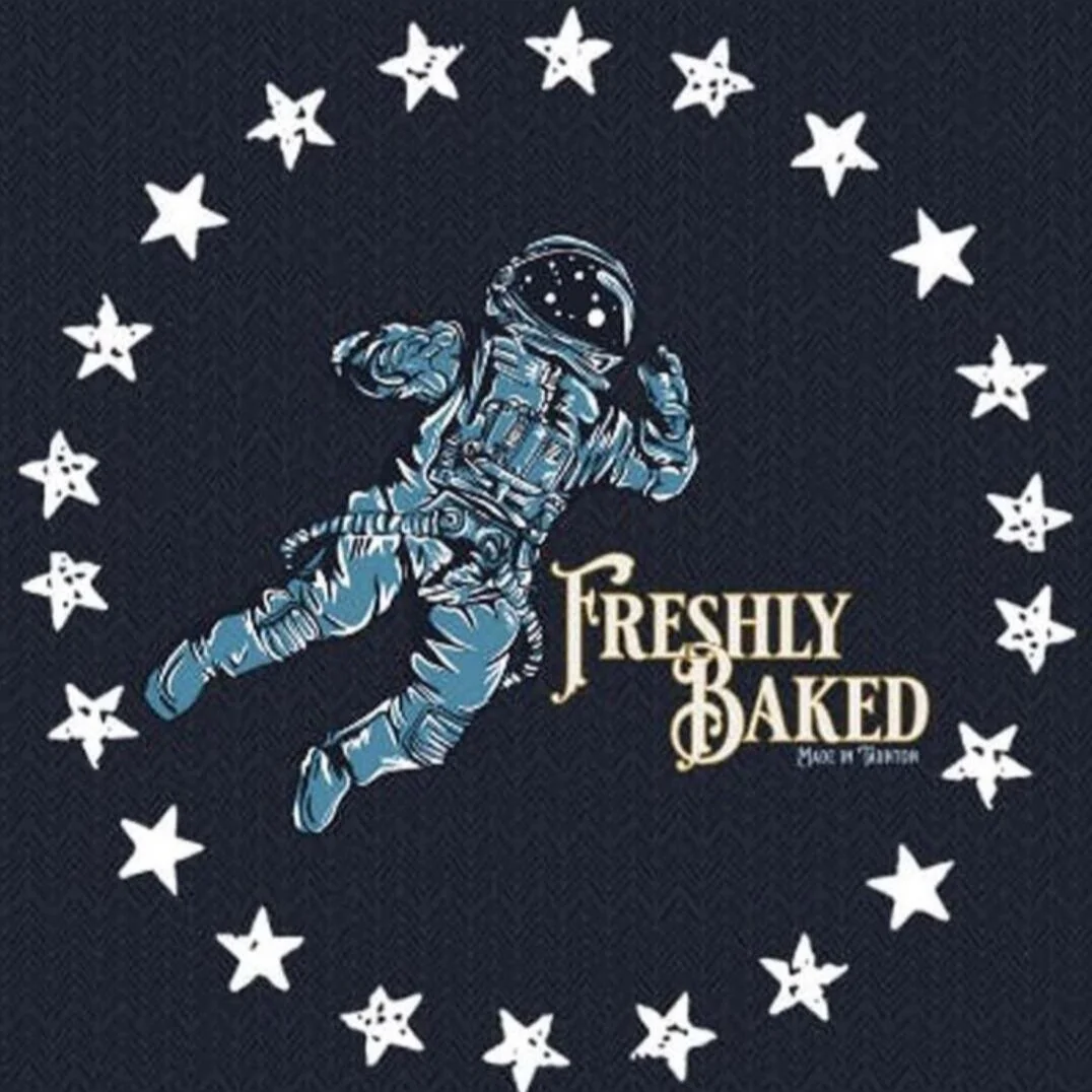 A graphic design featuring an astronaut floating, surrounded by white stars, with the text 'Freshly Baked' and 'Made in Tartton'.