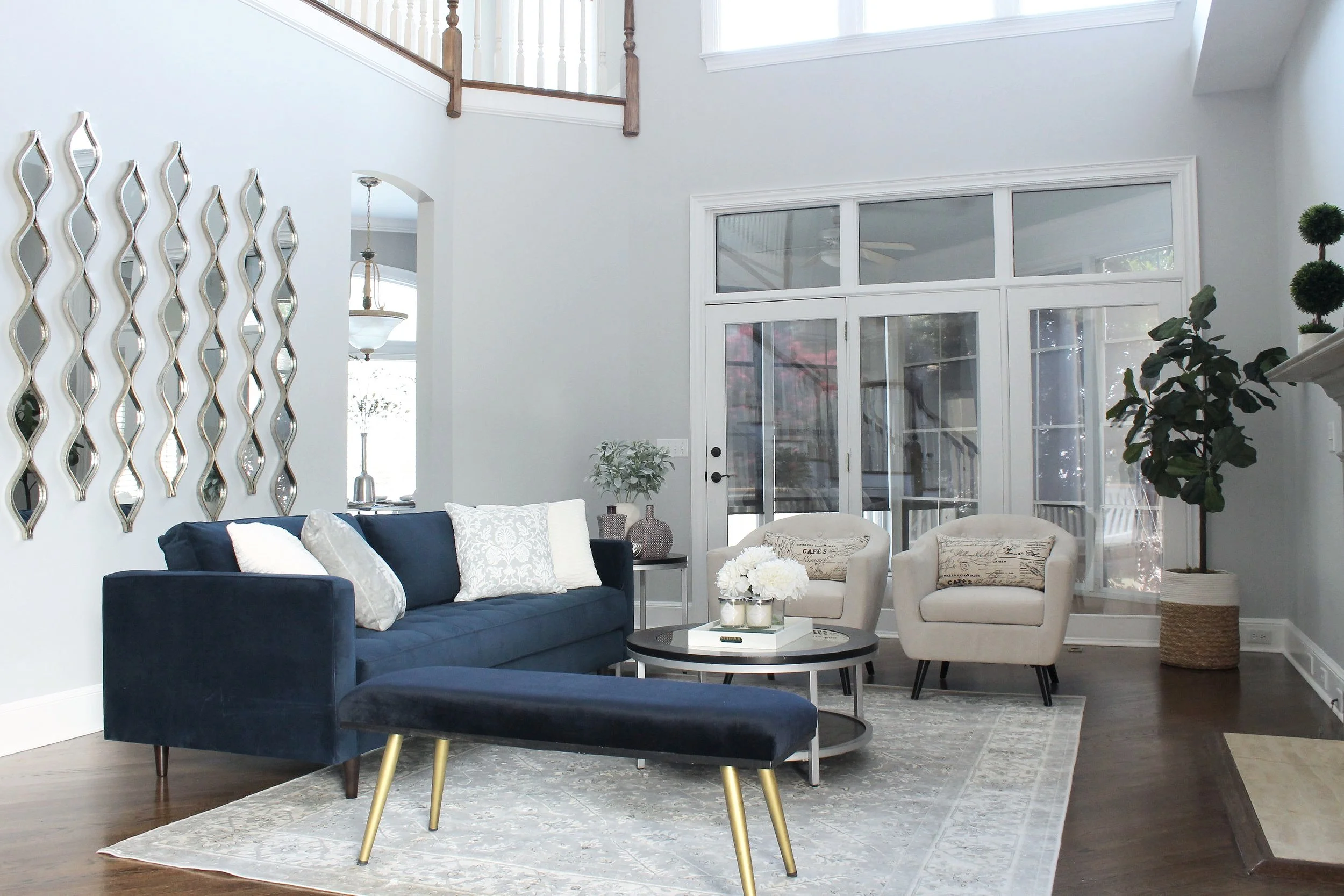 Living room blue sofa blue bench teardrop mirrors