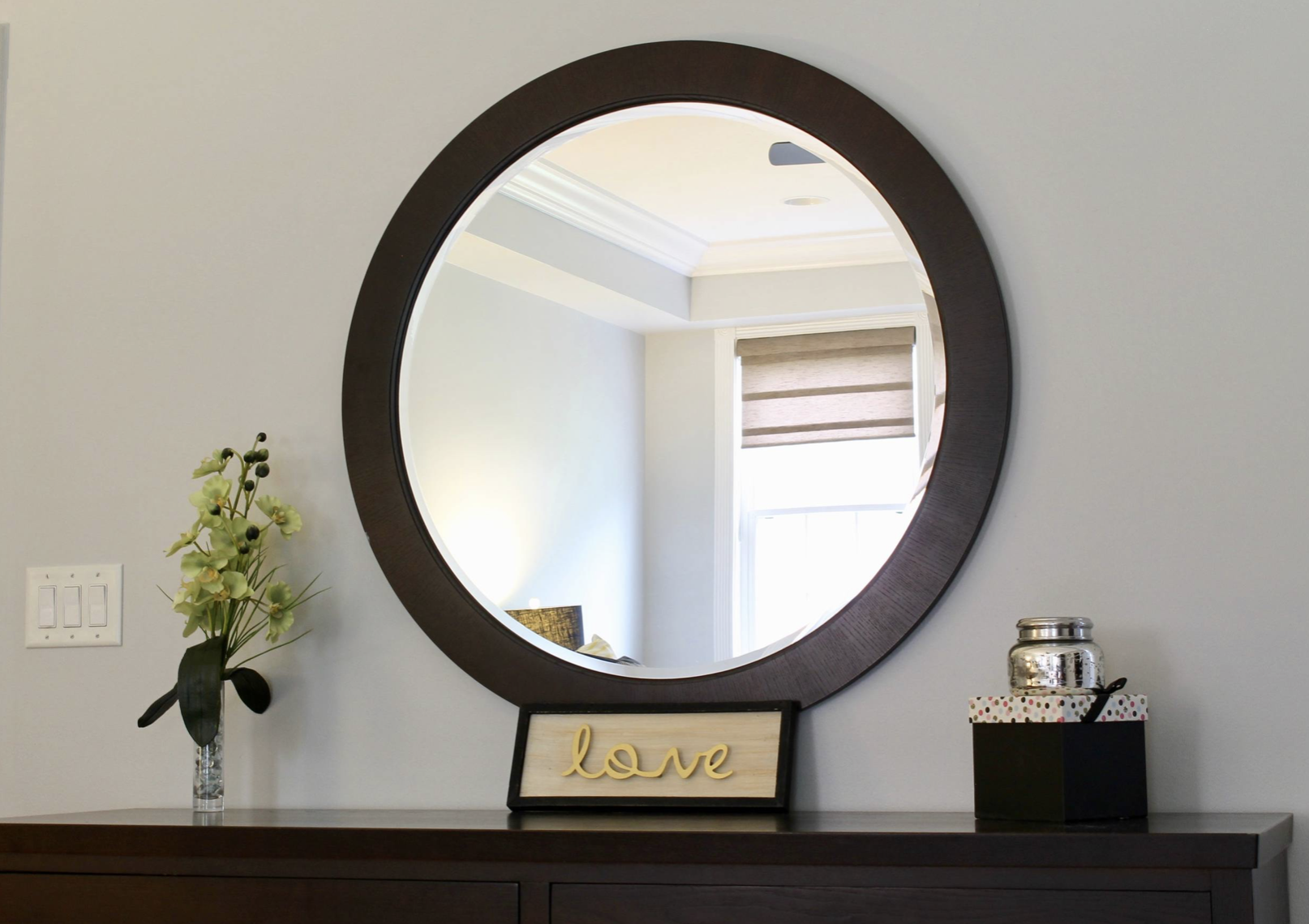 Master bedroom round wood frame mirror