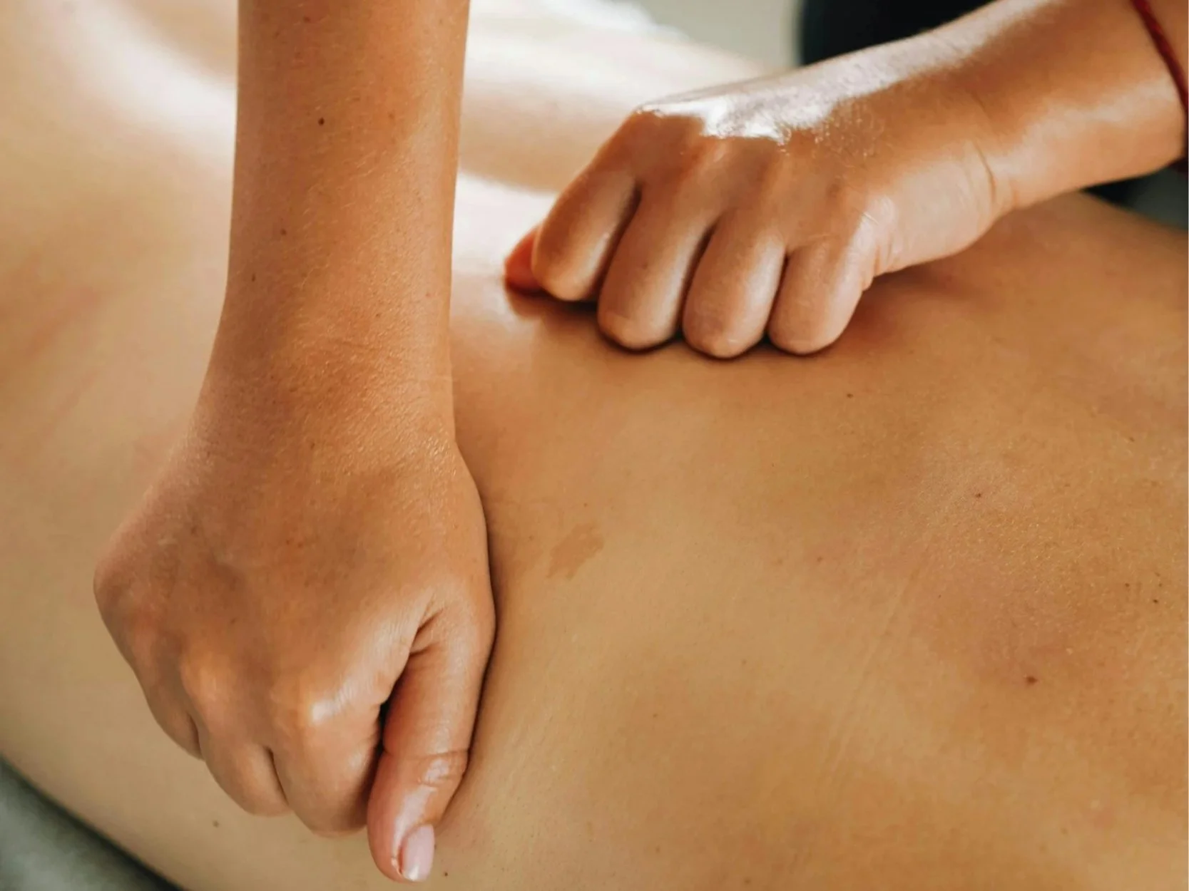 Person receiving a facial massage in a spa setting.