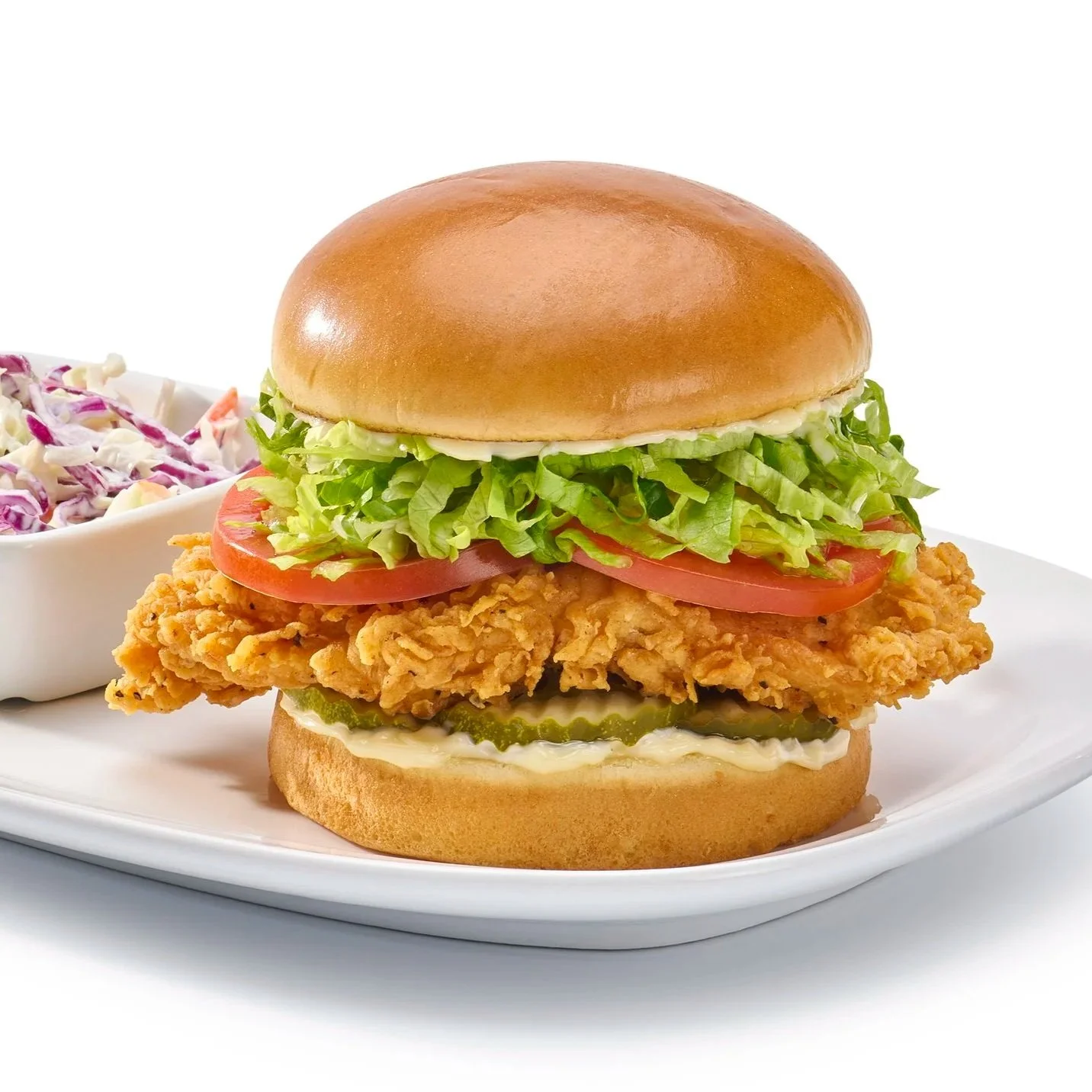 A tender hand breaded crispy chicken breast on a brioche bun with fresh tomatoes and lettuce. Denver based food stylist Kim Knotts Hicks for Red Robin.