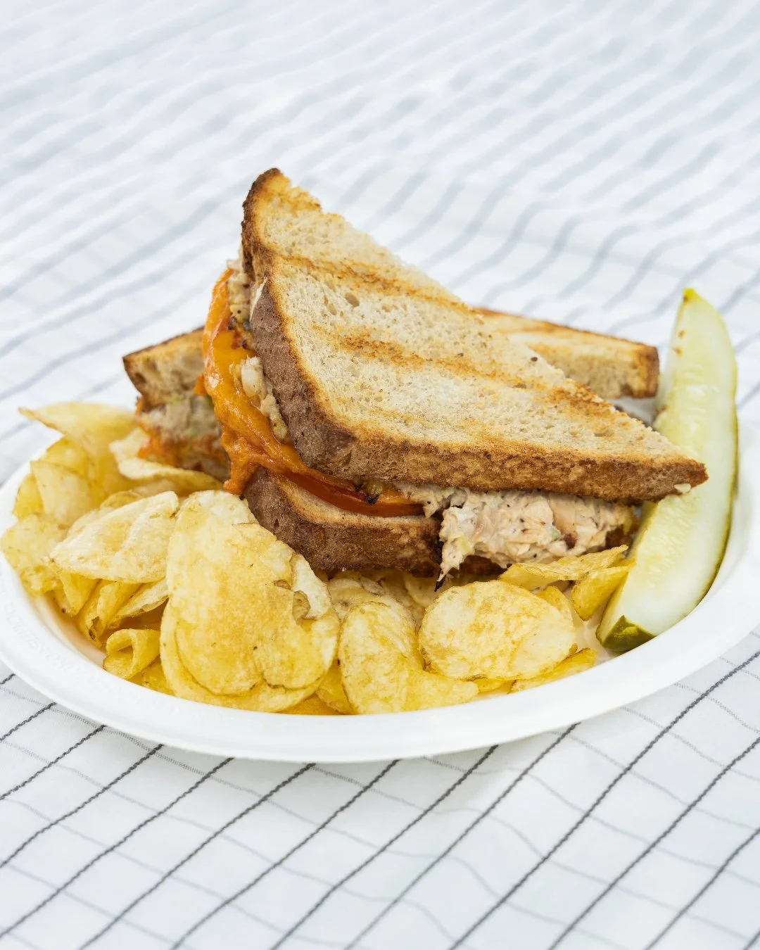 This month's made-to-order special is our house-made tuna salad on sourdough with cheddar cheese and tomatoes. Toasted to perfection and served with your choice of either chips &amp; a pickle OR carrots &amp; hummus.