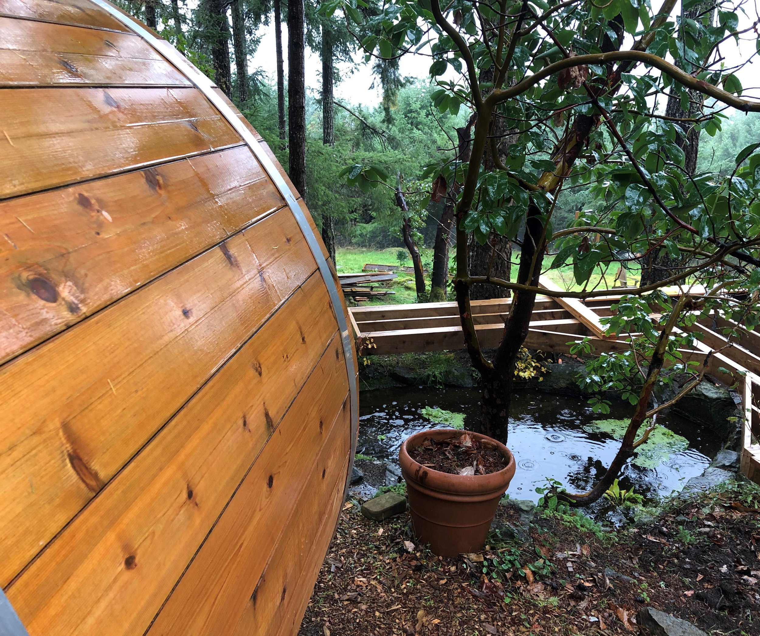 Barrel Sauna install above the pond