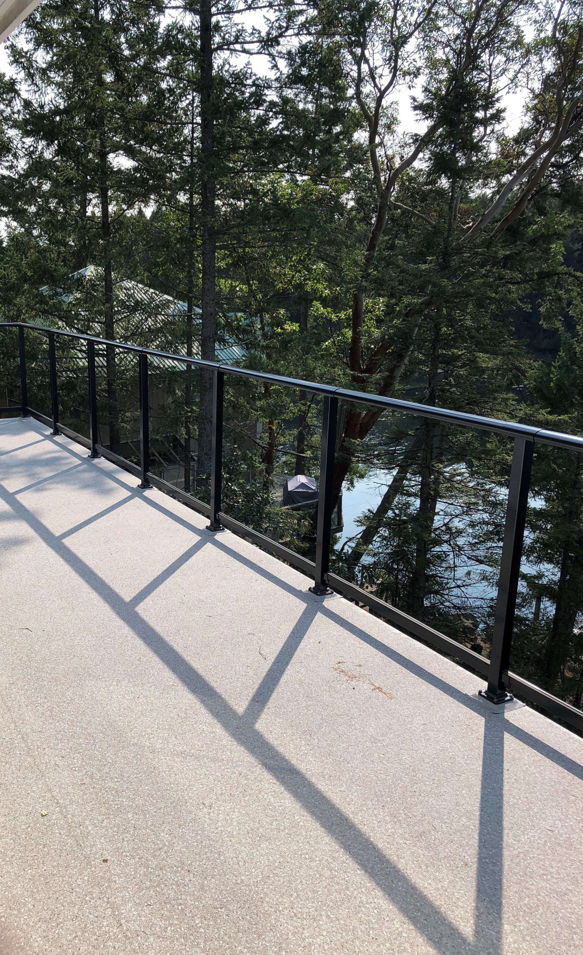 waterproof vinyl decking with black aluminium and glass railing