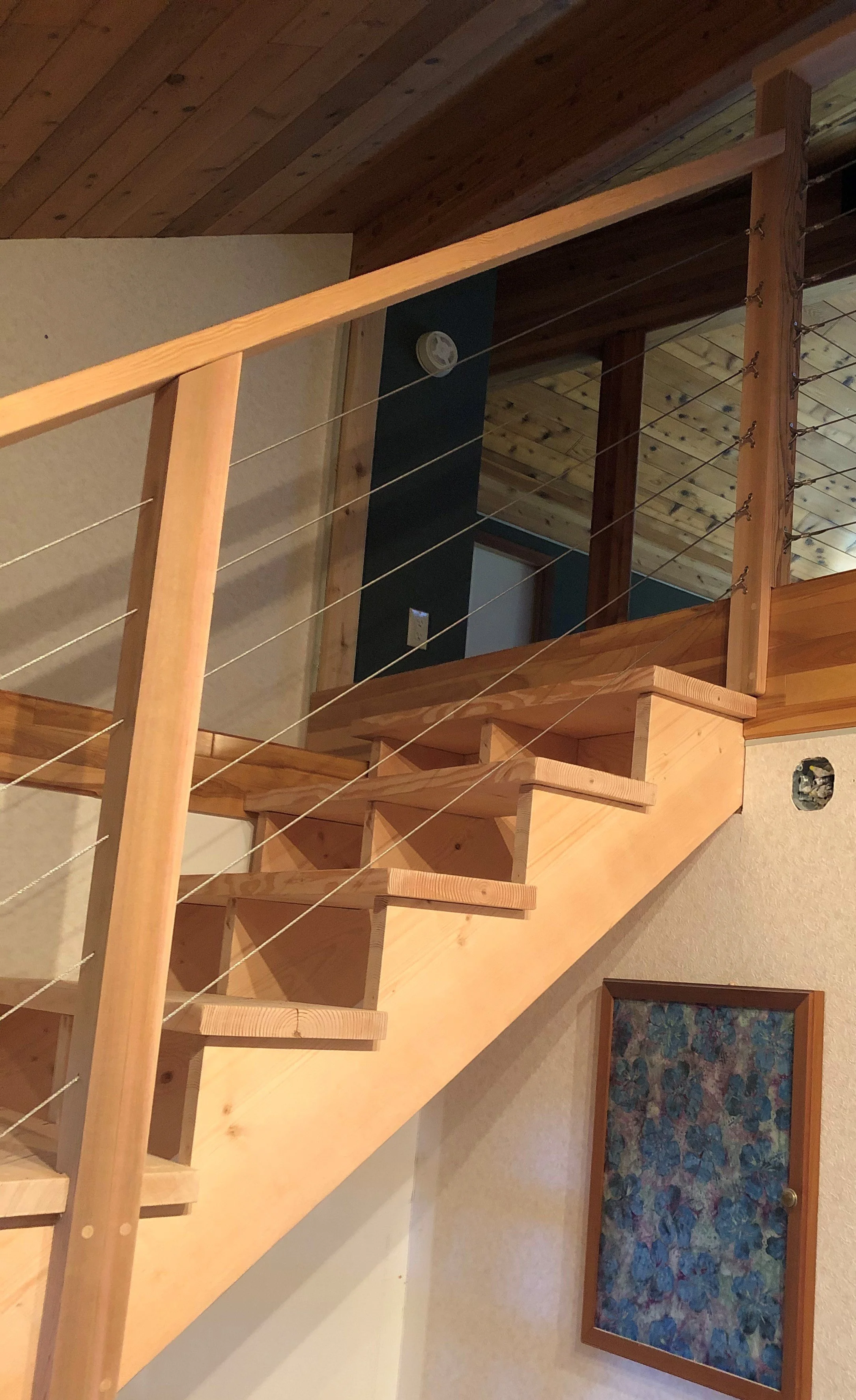 Interior cable railing on fir loft access staircase