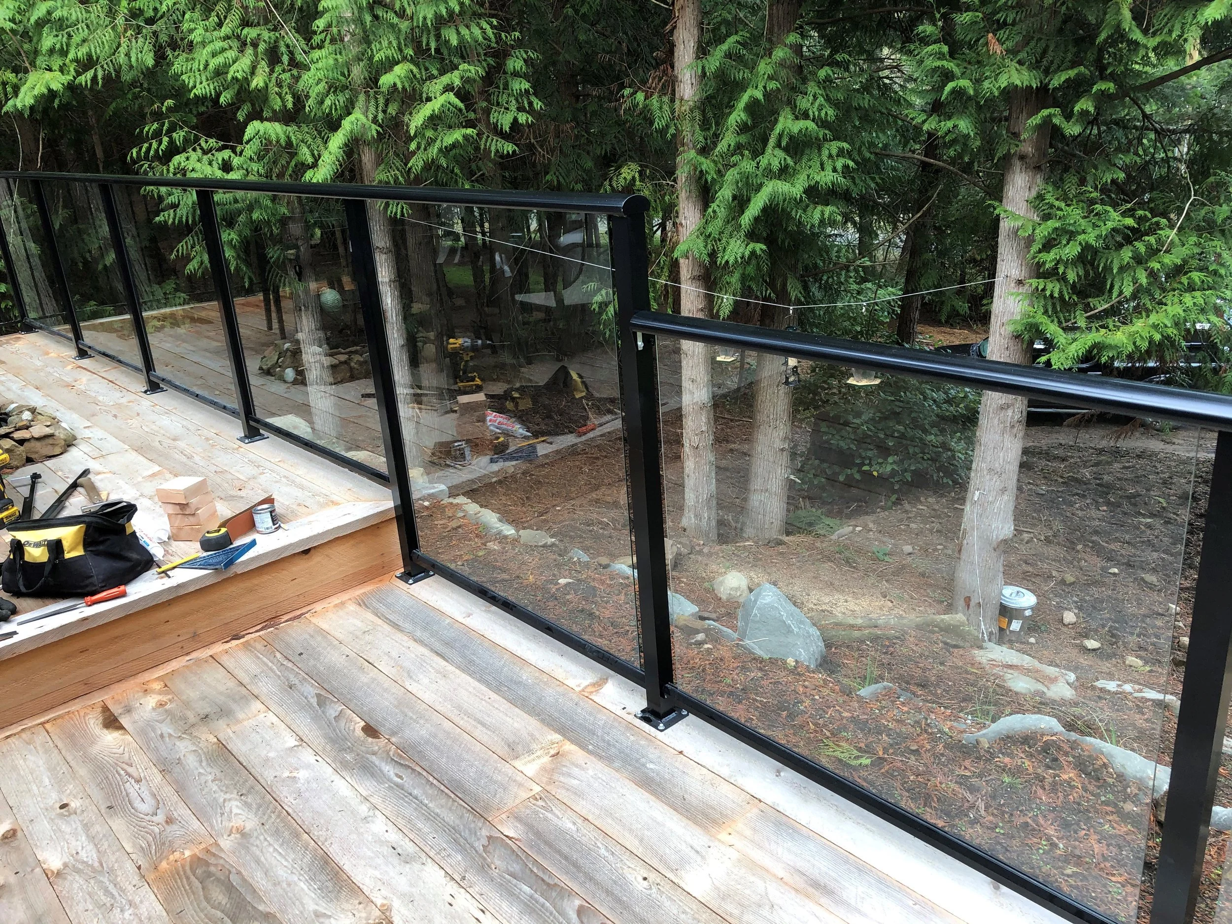 Black aluminium and glass railing on cedar decking
