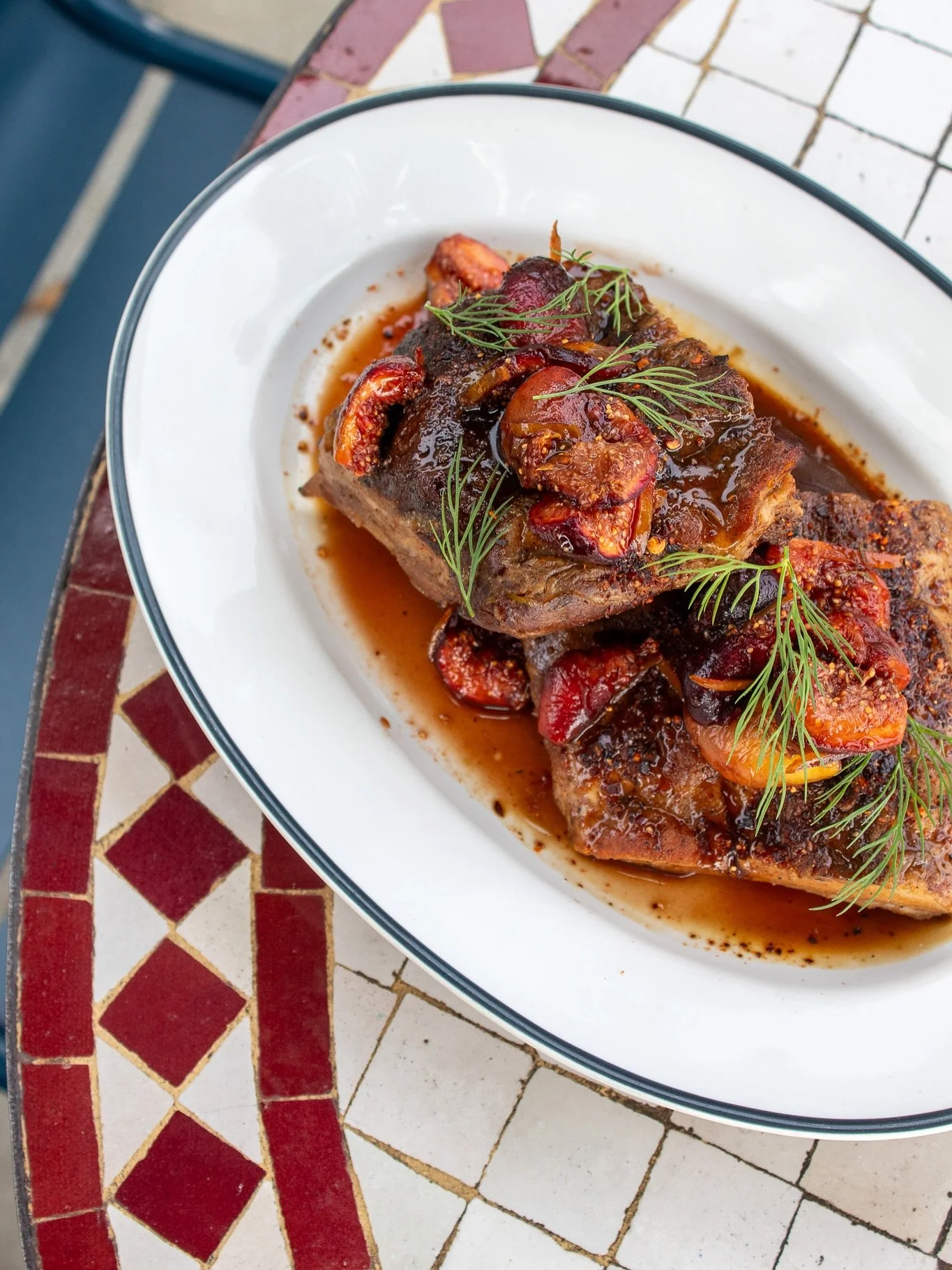 glazed pork ribs on the specials board this weekend! (friday & saturday) comes with a black fig agrodolce, cascabel chile and fennel tops 🤌