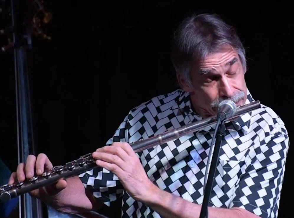 Daniel Jordan plays flute during a performance