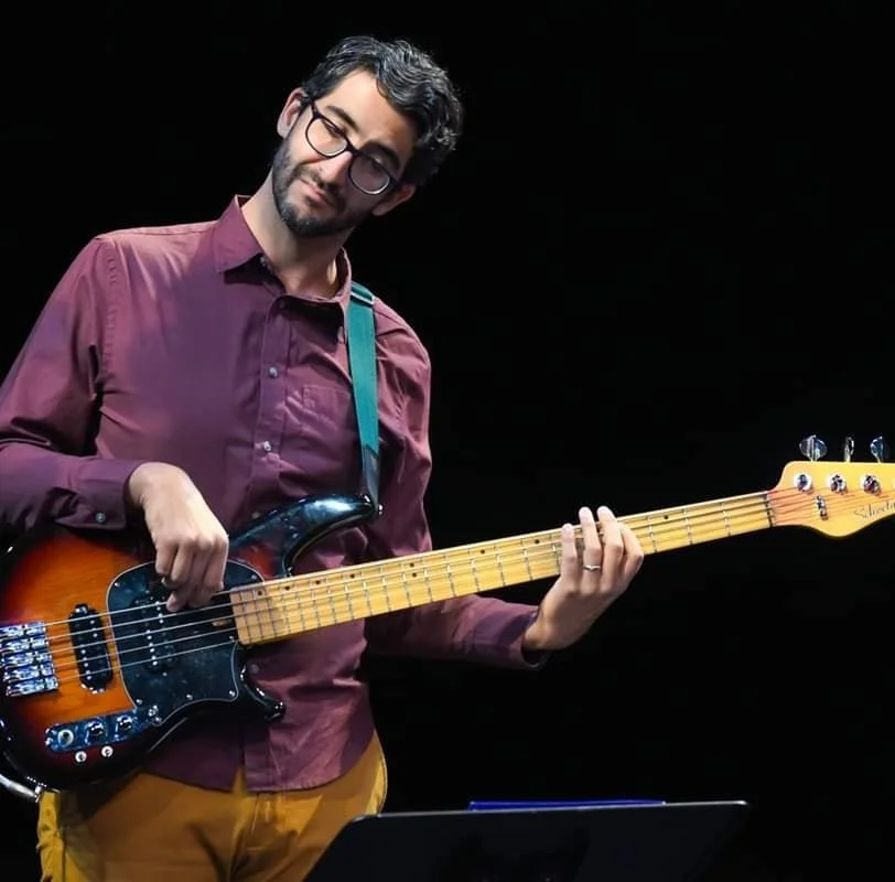 Alejandro Arenas performs with bass guitar