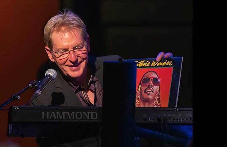 Stretch Bruyn displays a Stevie Wonder album at a performance