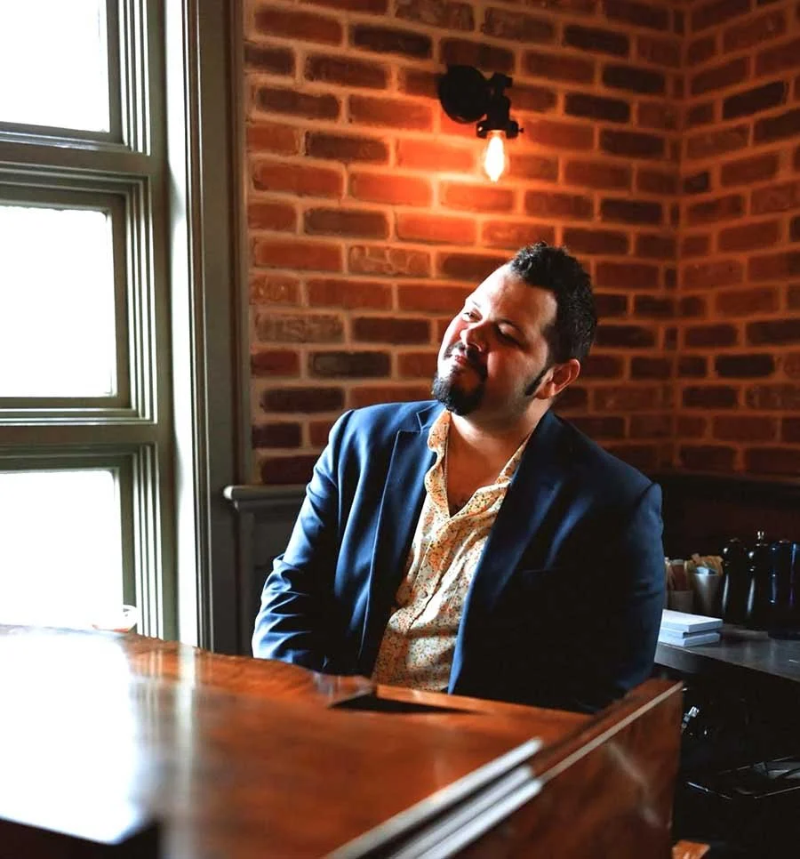Rafael Silva sits at the piano