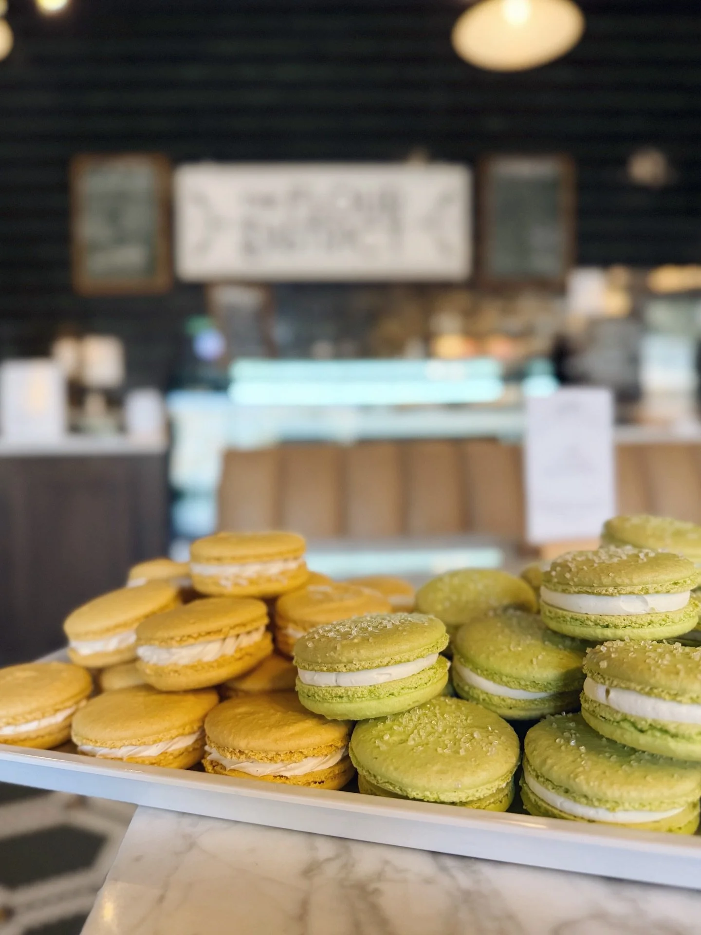 Honey Vanilla &amp; Key Lime macarons in the case - tasty as ever! 💛💚