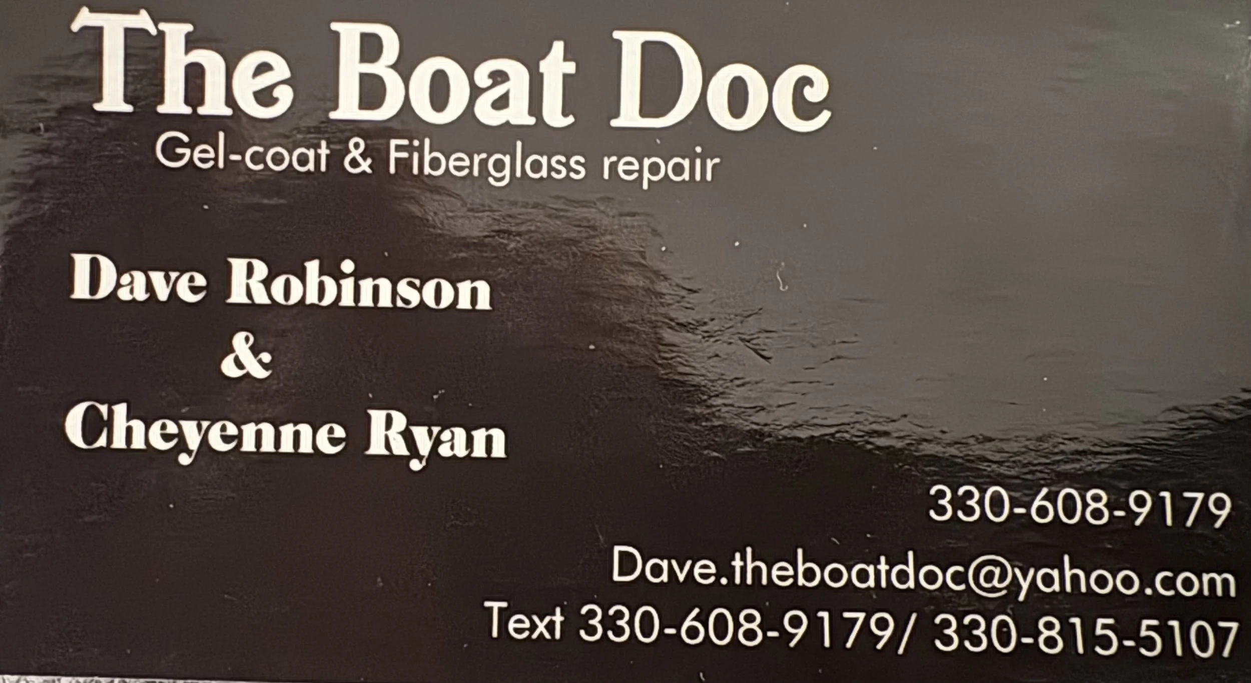 Business card for The Boat Doc with contact details and email, against a dark background with a water scene.