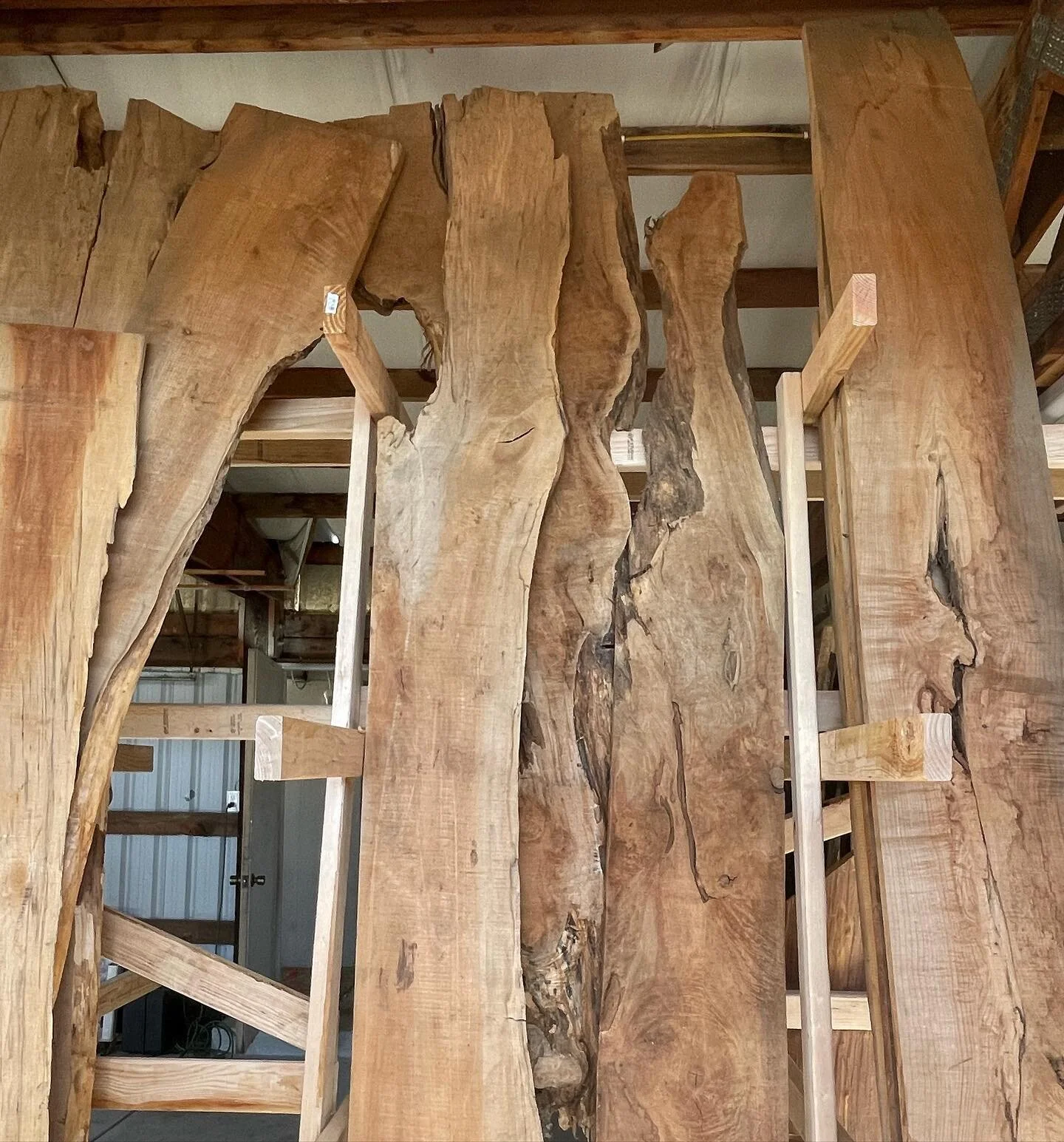 More wood arriving next weekend!  We&rsquo;ve been building shelves and organizing what we have so far. Check out those sexy live edge slabs 😍🤤 

.
.
.

#liveedgeslab