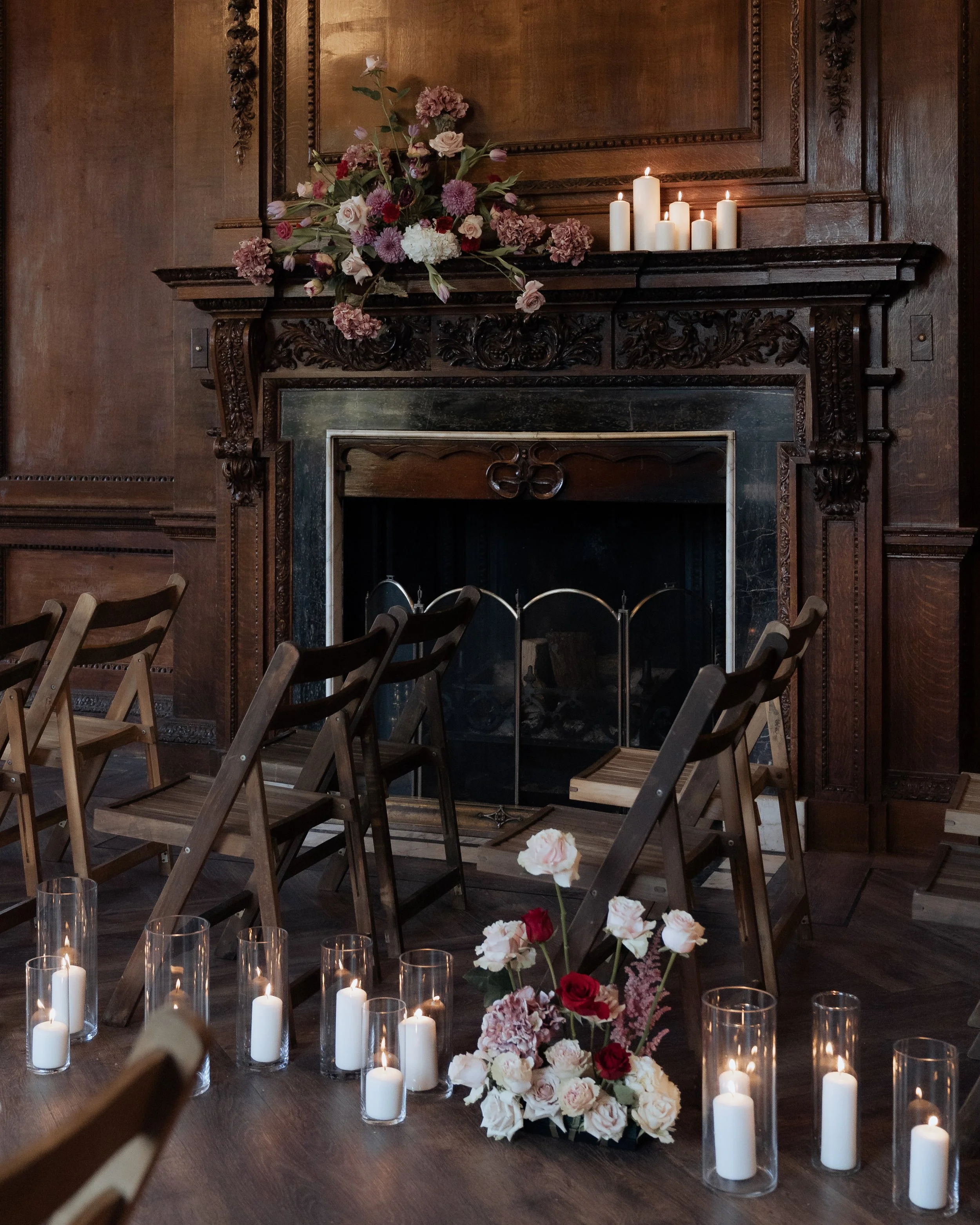 An intimate ceremony setting within a historic manor house, styled with soft florals, candlelight and layered textures. Captured with an editorial approach, this scene reflects a calm, romantic atmosphere where timeless interiors and thoughtful styli