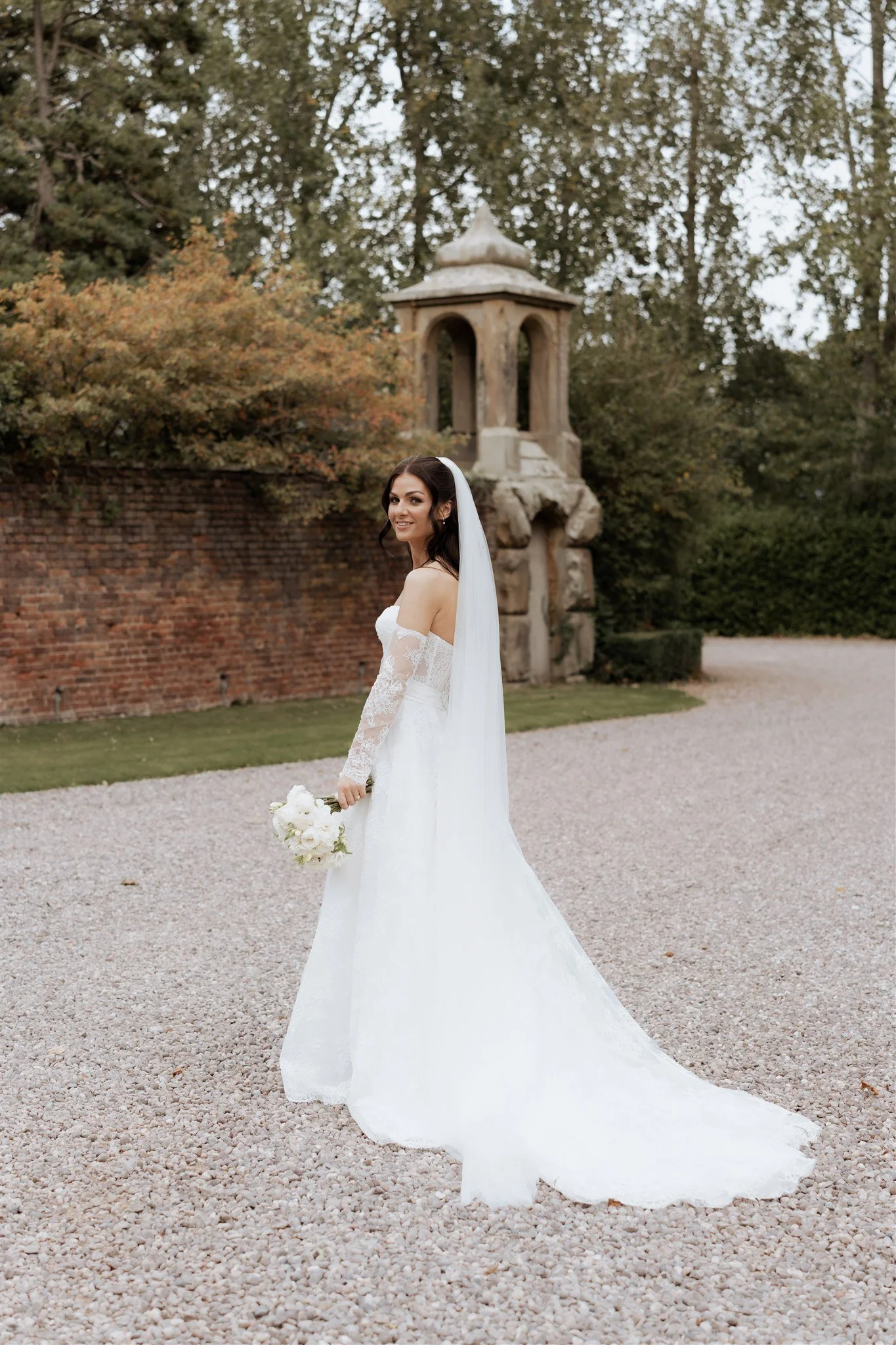 A timeless bridal portrait taken on the grounds of Soughton Hall. Framed with historic textures and open space, this image highlights elegant simplicity and a calm, fashion-led bridal presence.