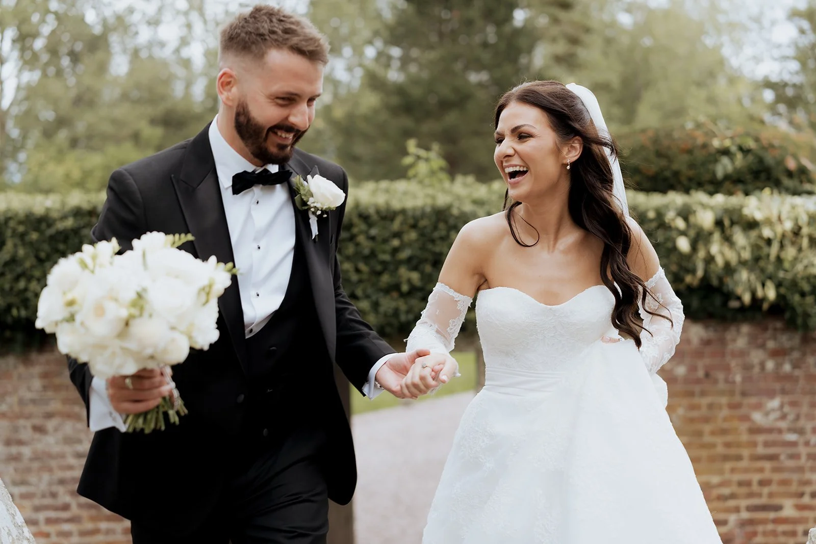 Bride laughing during wedding speeches, captured in a natural editorial style ideal for elegant Cheshire venues such as Hawkstone Hall.