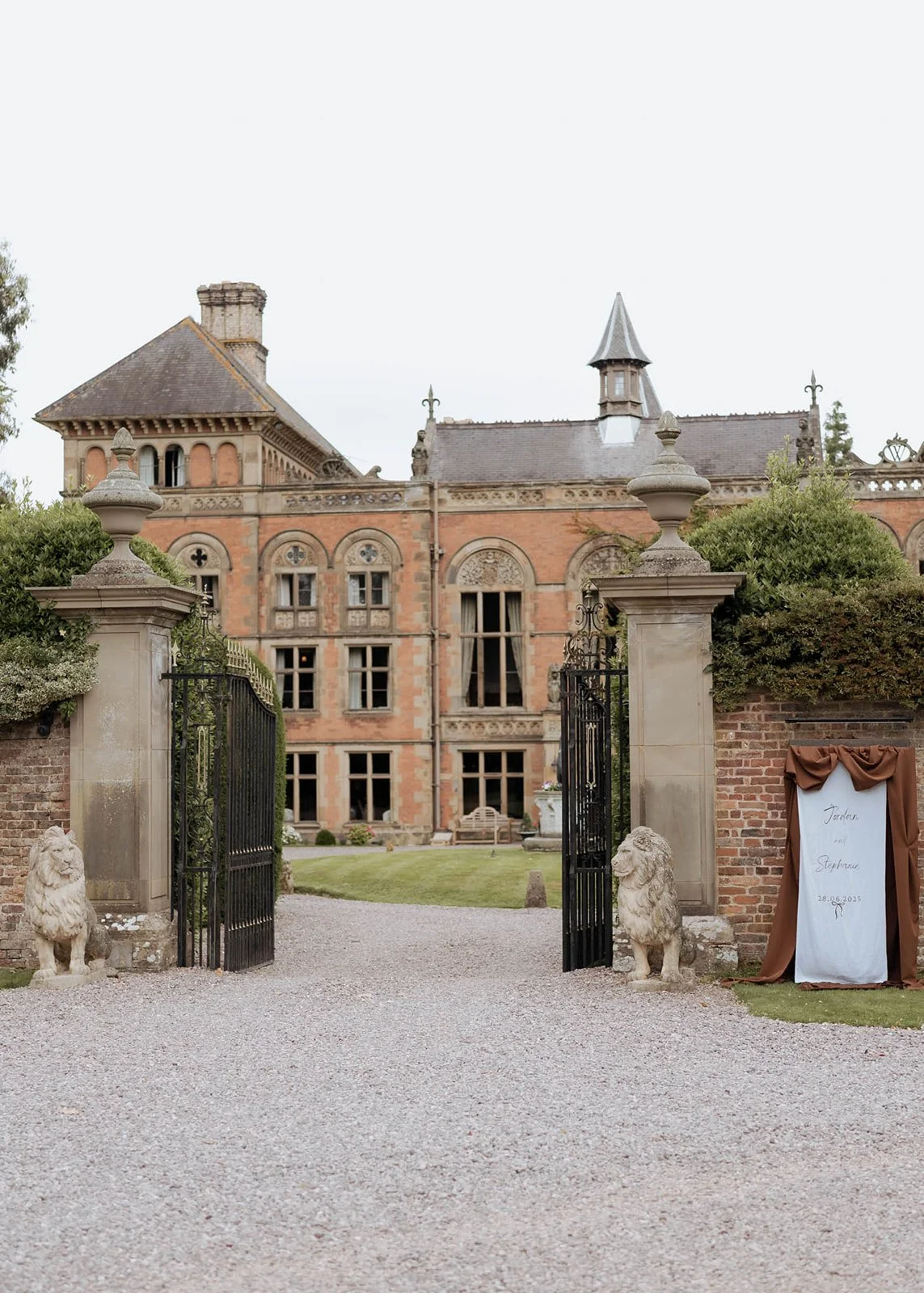 The grand Georgian façade of Soughton Hall, a timeless manor house in North Wales, captured in soft natural light. A venue celebrated for its architectural elegance, sweeping grounds, and refined wedding celebrations.