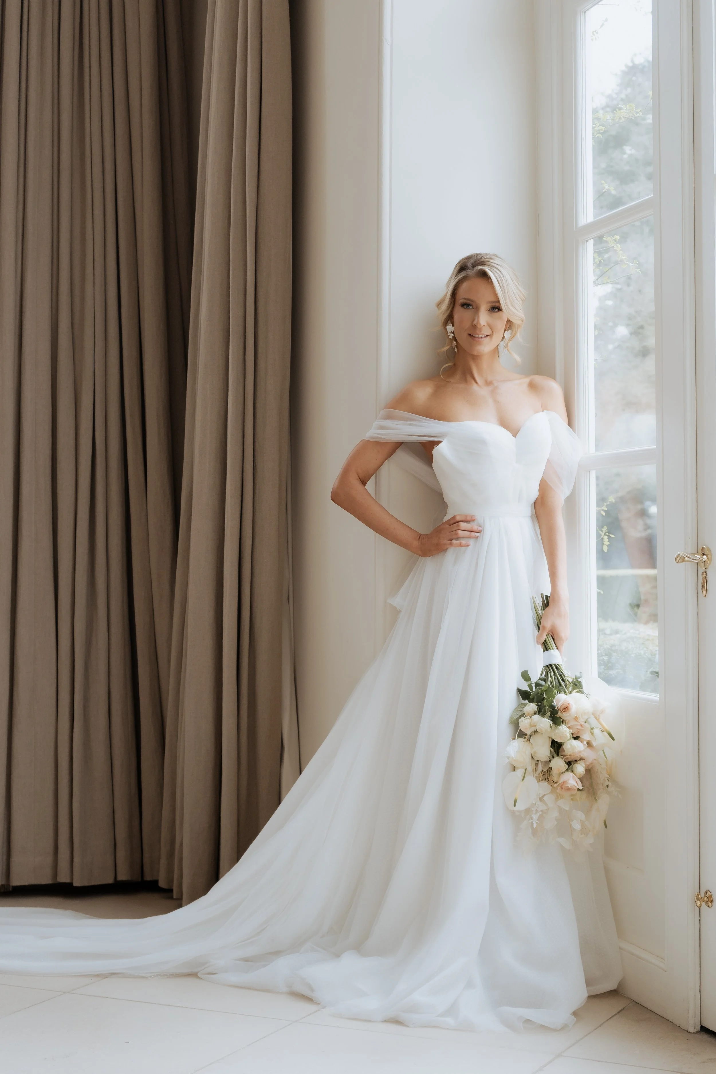Bride portrait in soft window light inside Iscoyd Park, photographed in an editorial wedding style