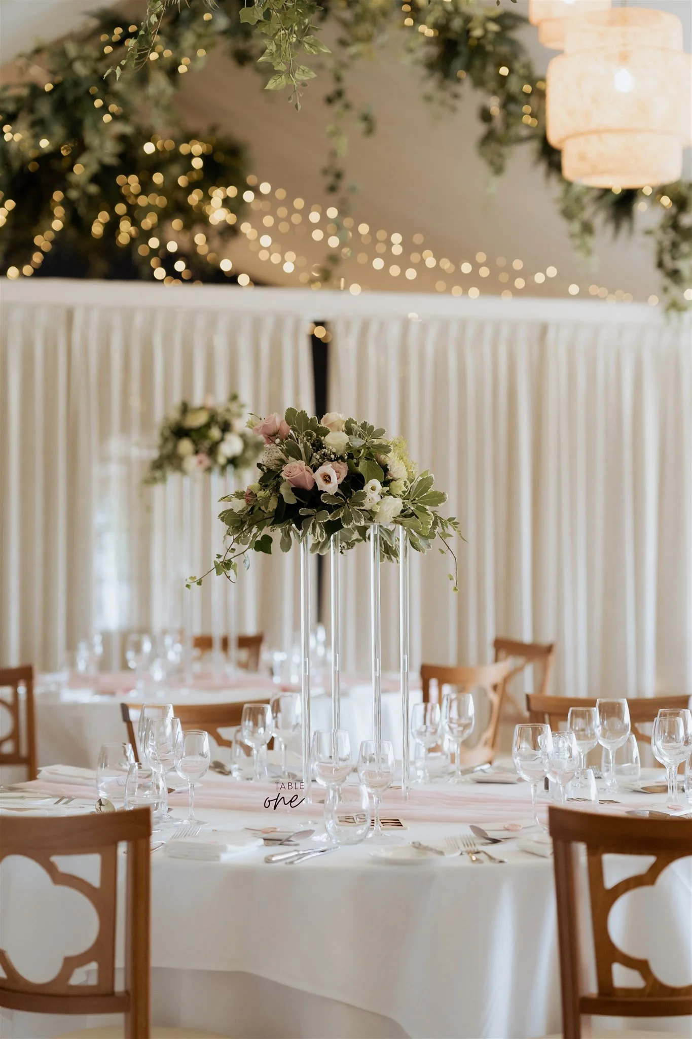 Elegant wedding table styling at Combermere Abbey with soft floral centrepieces, candlelight tones and refined reception details.