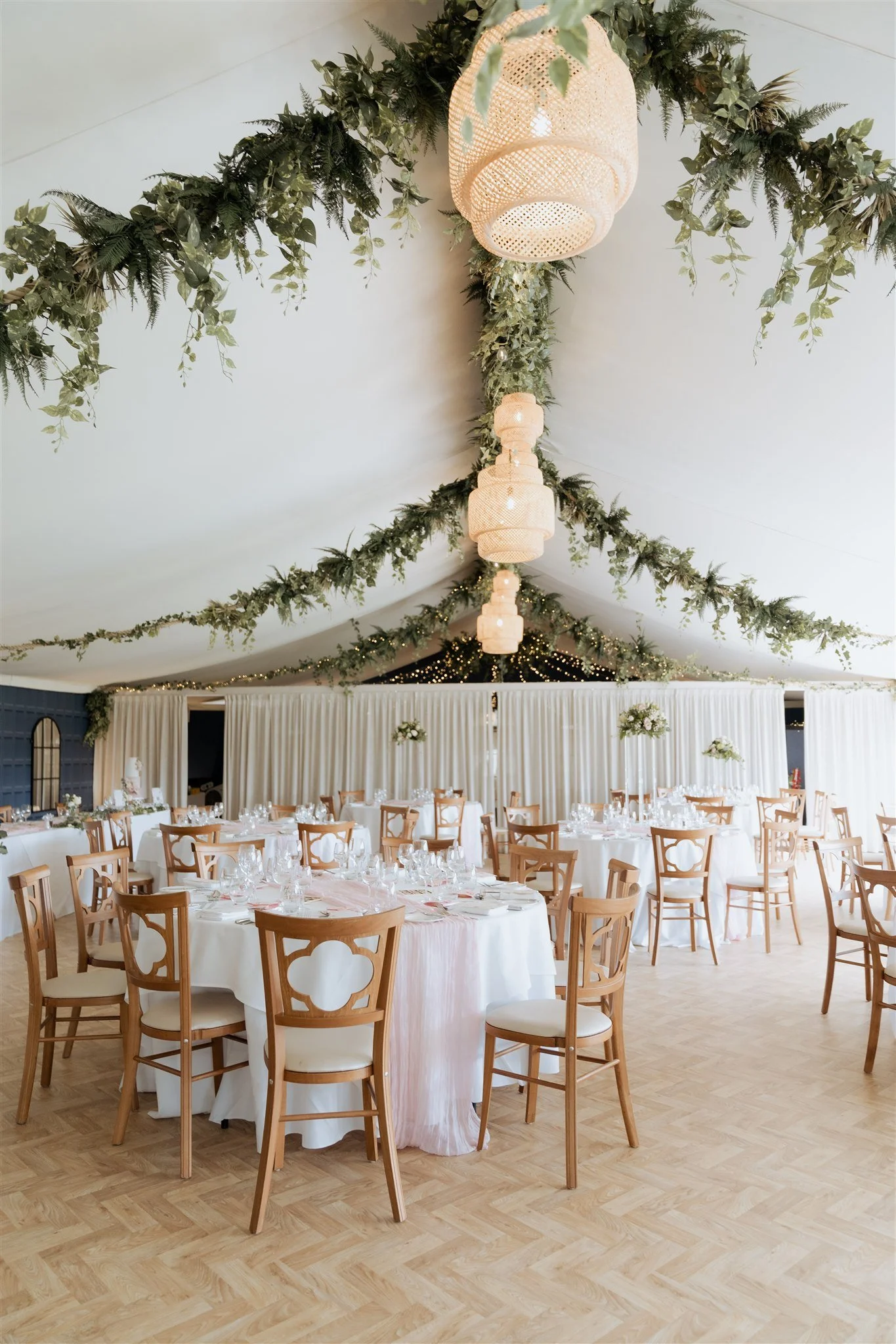 Elegant wedding reception styling inside the marquee at Combermere Abbey with modern romantic décor and refined floral installations.