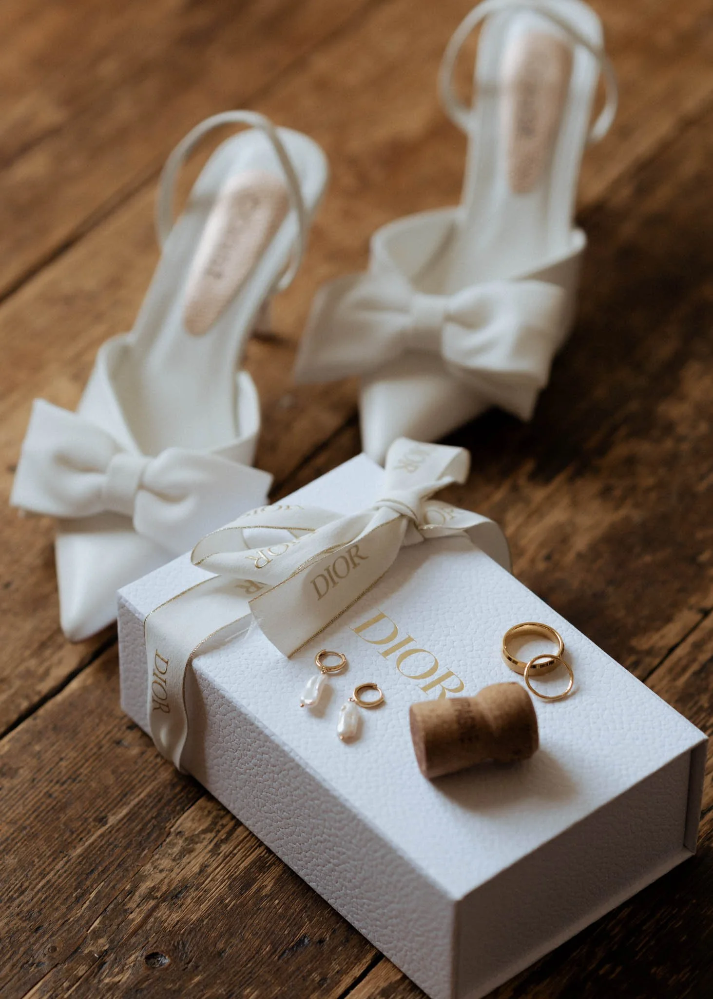 A refined still life of bridal details photographed at Soughton Hall, styled with soft ivory tones, silk textures and delicate jewellery for a timeless, editorial feel.