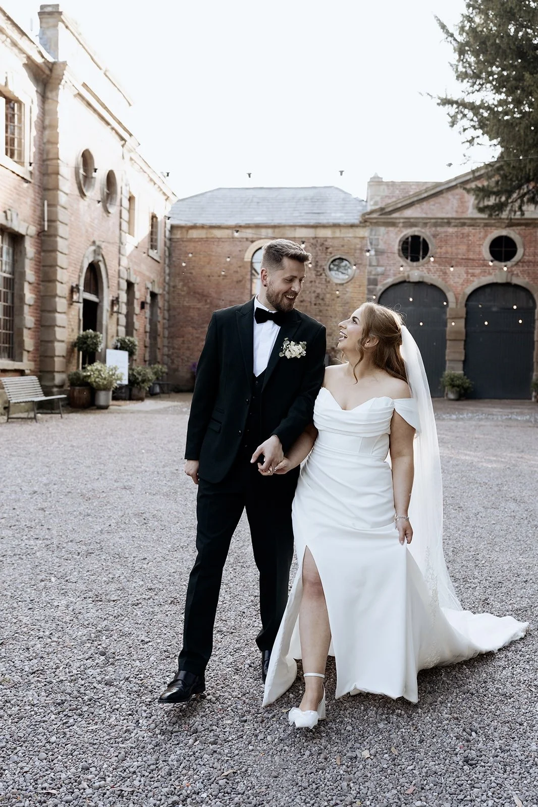 Editorial wedding photograph of a bride and groom at The Coach House wedding venue in the UK, captured with a relaxed, documentary approach.