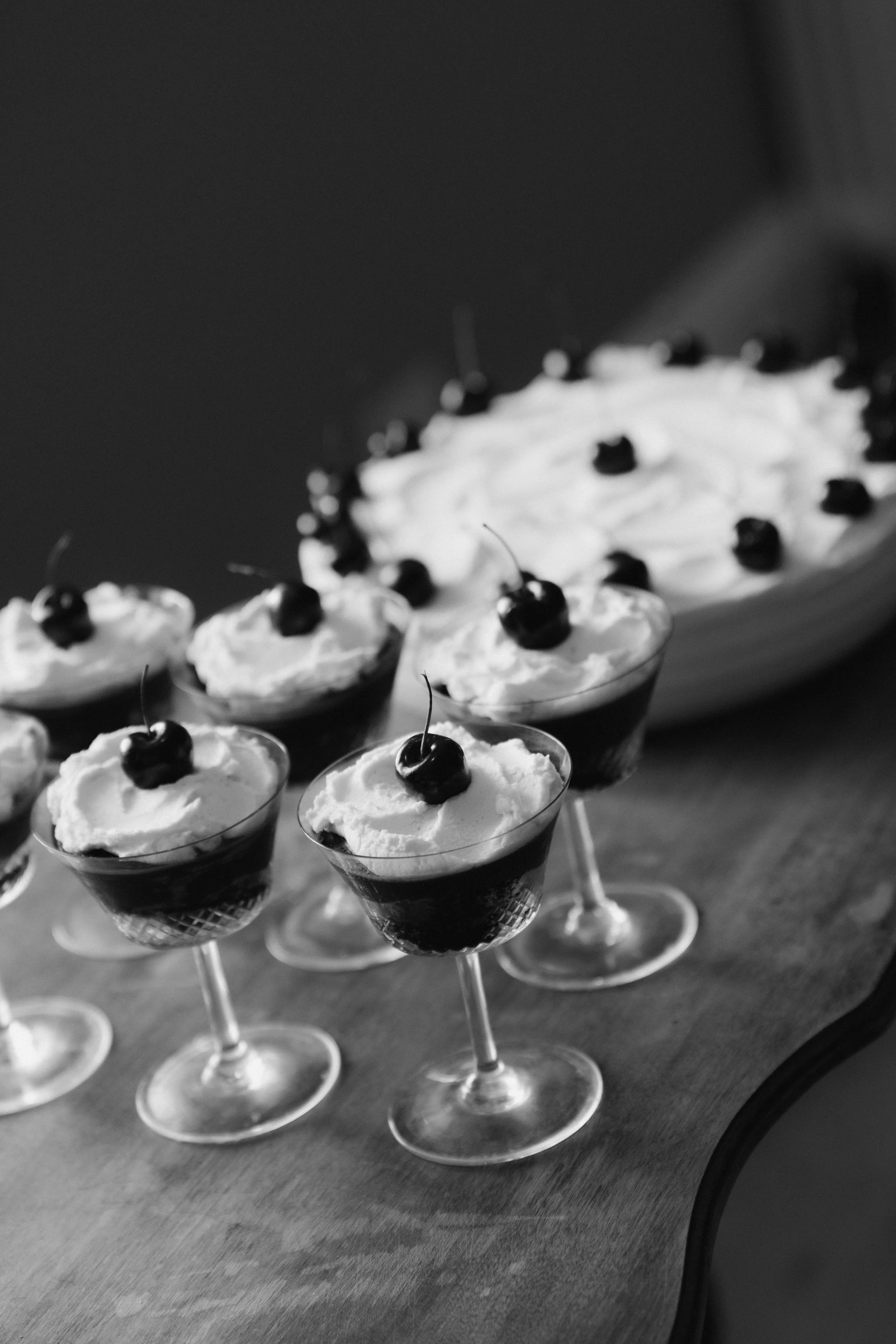 Fine-art black and white detail shot of sophisticated wedding desserts served in crystal glasses — timeless styling for luxury weddings at elegant UK venues