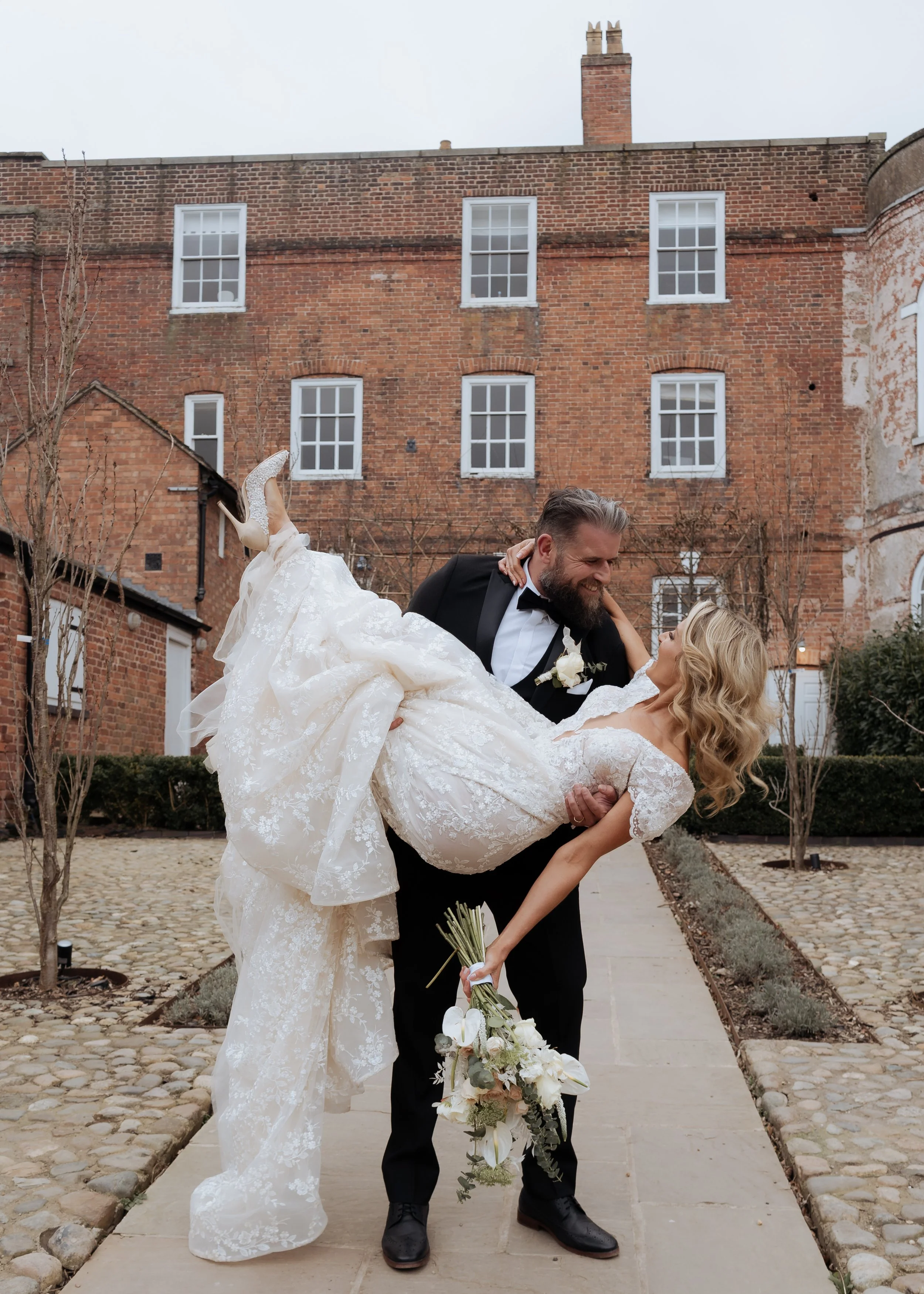 Bride and groom sharing a joyful outdoor moment at Iscoyd Park, photographed in an editorial wedding style