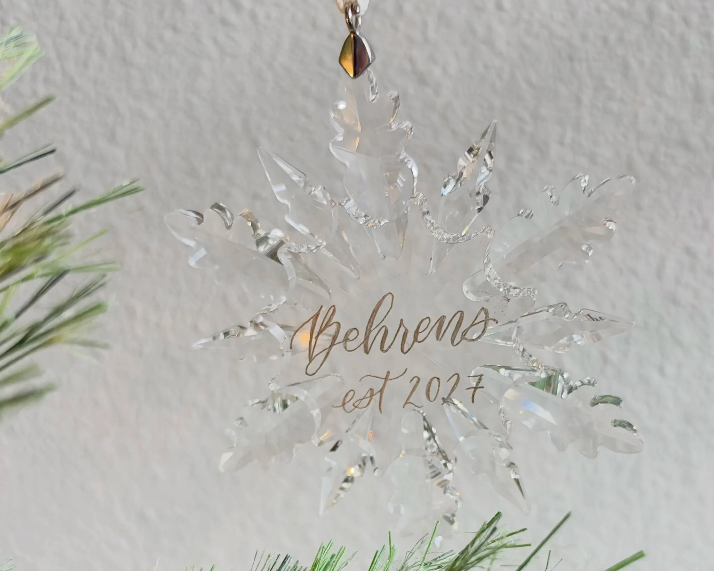Crystal Snowflake ornament with the words "Behrens est. 2027" engraved in gold calligraphy