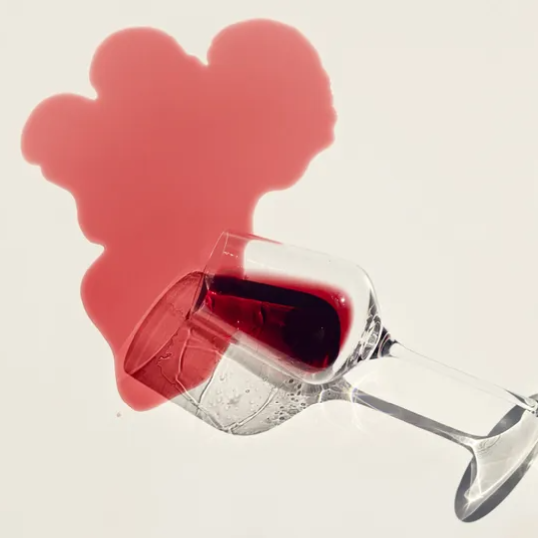 red wine spilled from a tall wine glass
