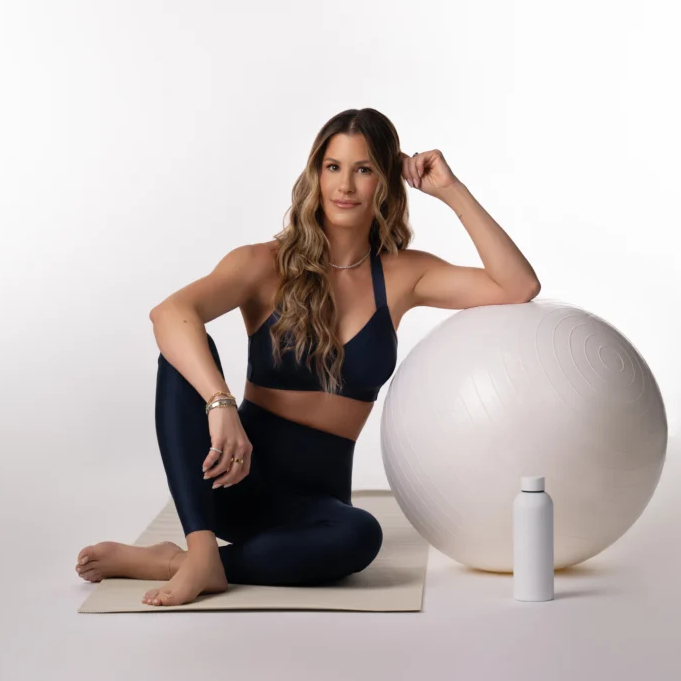 woman resting arm on yoga ball