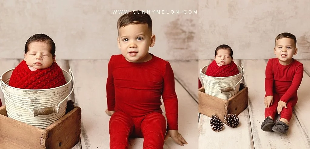 Professional "Baby's First Christmas" brother and newborn sibling photography session with rustic red and white props.