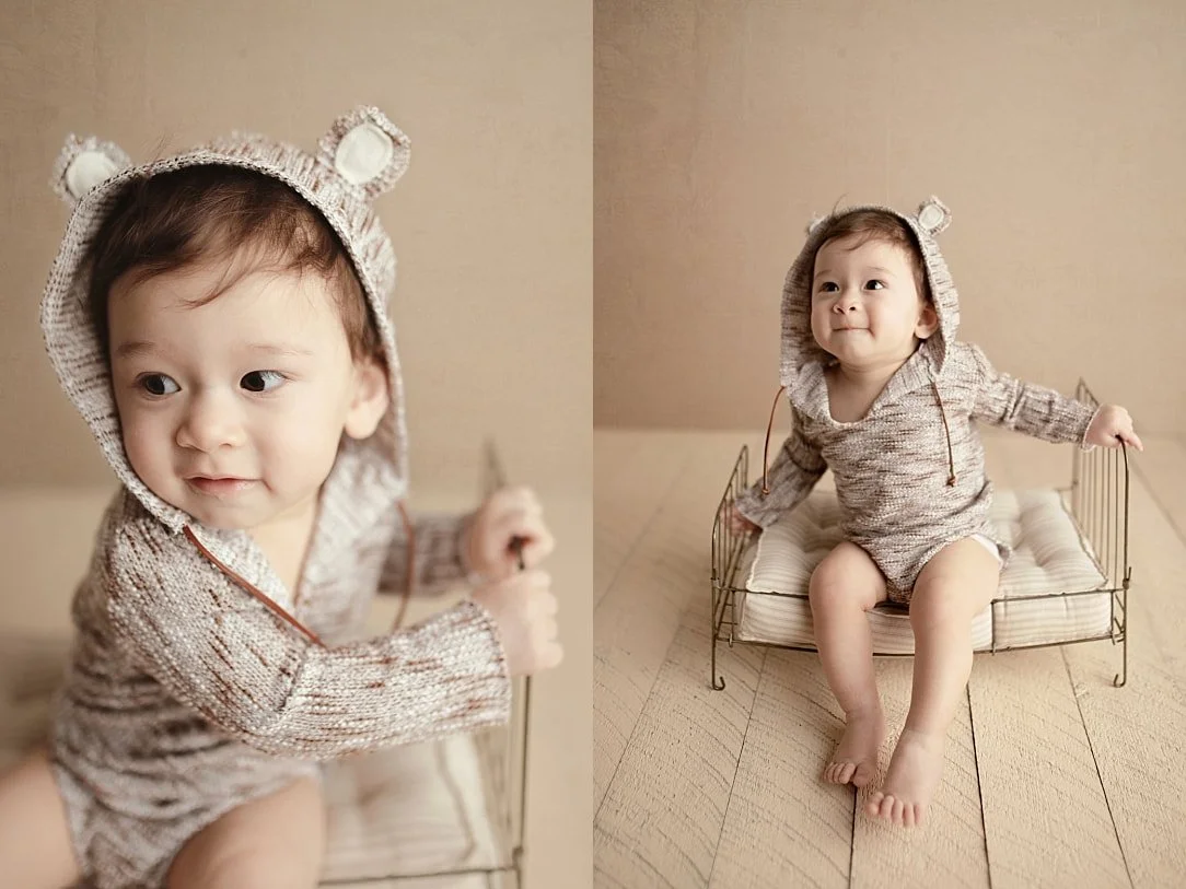 A side-by-side studio collage of an older infant in a knit bear-ear hoodie. The left image is a close-up profile of the baby; the right shows the infant sitting on a small vintage metal bed prop on a light wooden floor.