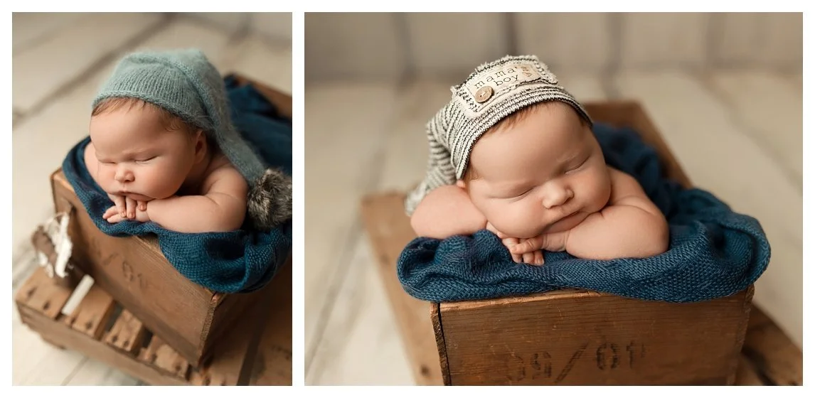 A two-image studio collage inside a wooden crate with a slate blue blanket; the left shows a sleeping baby in a long knit bonnet, and the right shows a close-up profile wearing a "mama's boy" cap.
