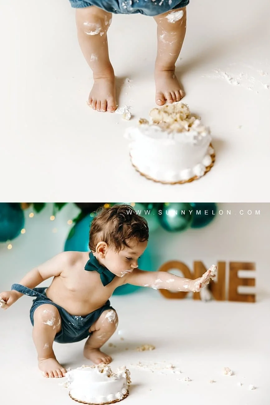 Toddler boy in blue overalls playing with a wooden horse and balloons during a first birthday photoshoot.