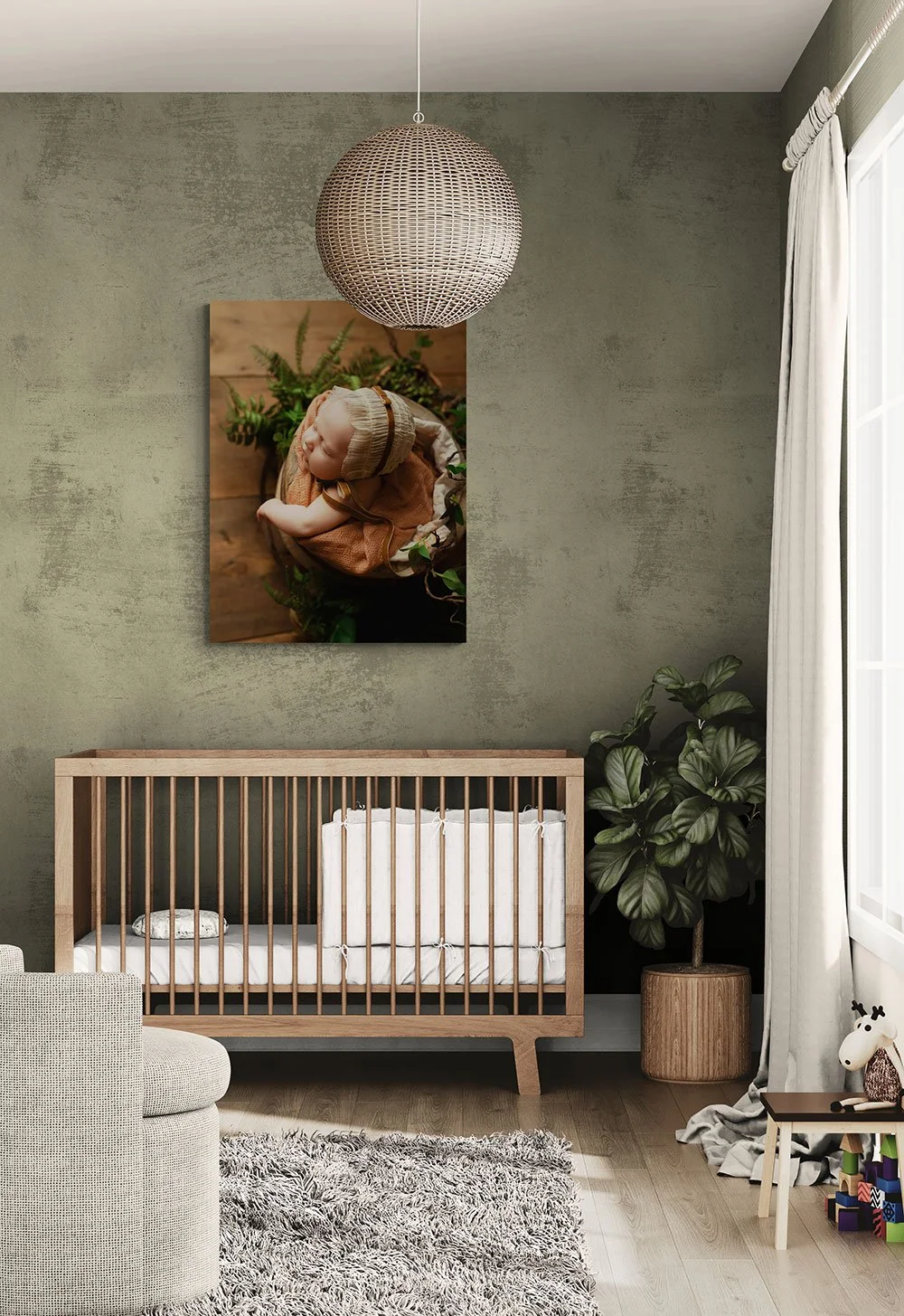 Vertical fine-art newborn canvas print mockup hanging over a natural wood spindle crib on a textured sage green nursery wall.