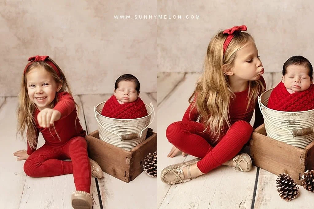Christmas newborn sibling portrait with big sister in red and baby in a white bucket.