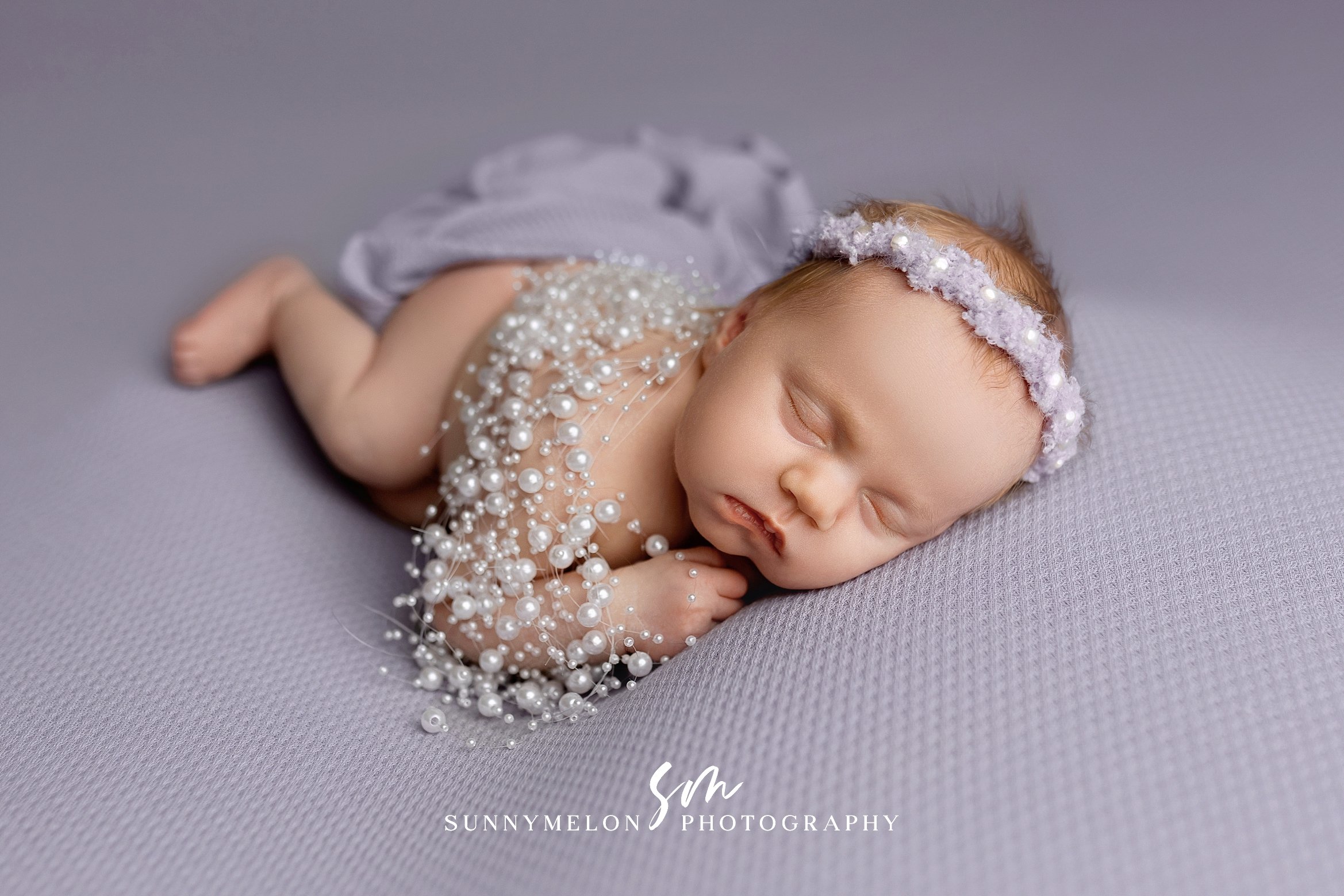 Artistic Lavender Newborn Portrait with Pearl and Lace Details