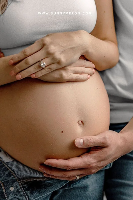 Intimate Macro Maternity Portrait: Hands Cradling Baby Bump