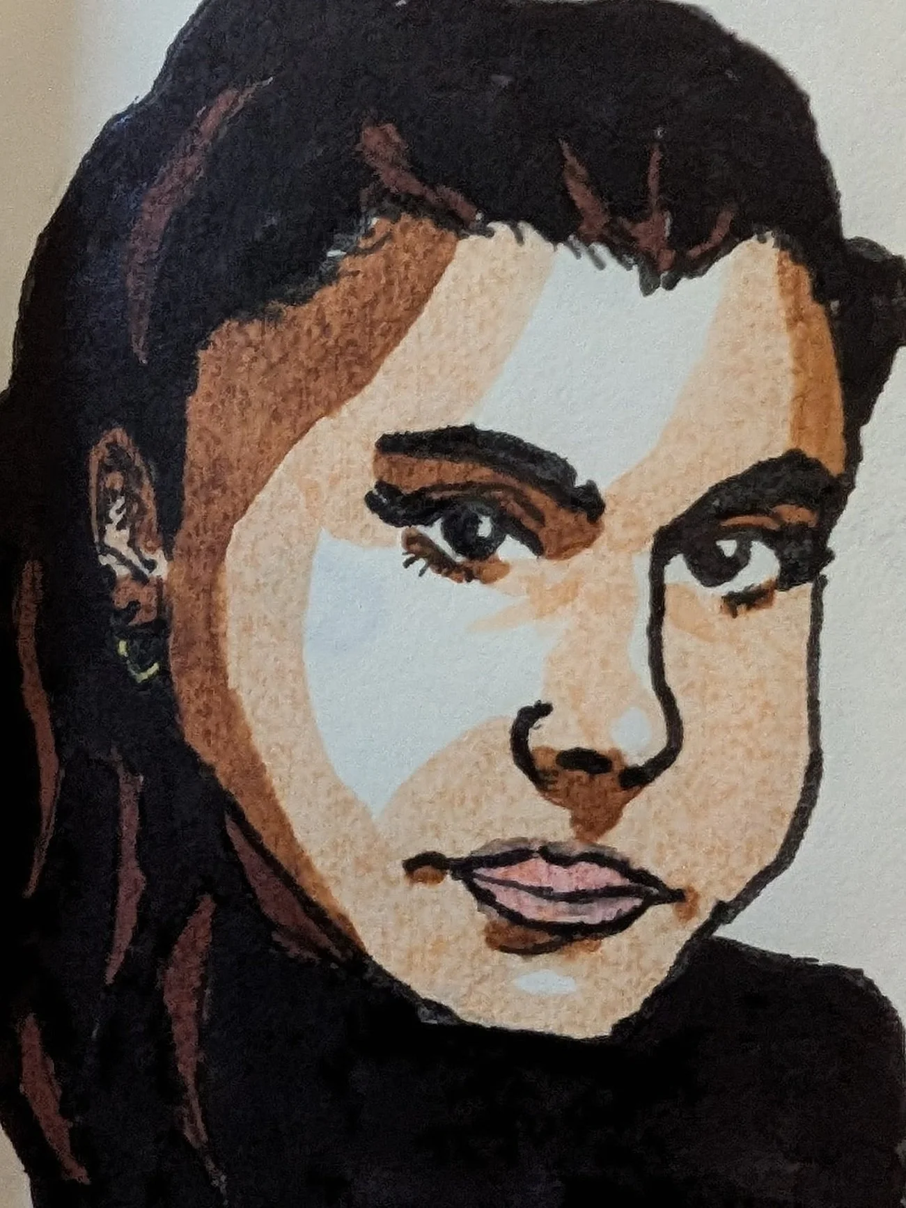 Woman with long black hair and earing, frowning slightly, with skin color divided sharply into three shades of brown