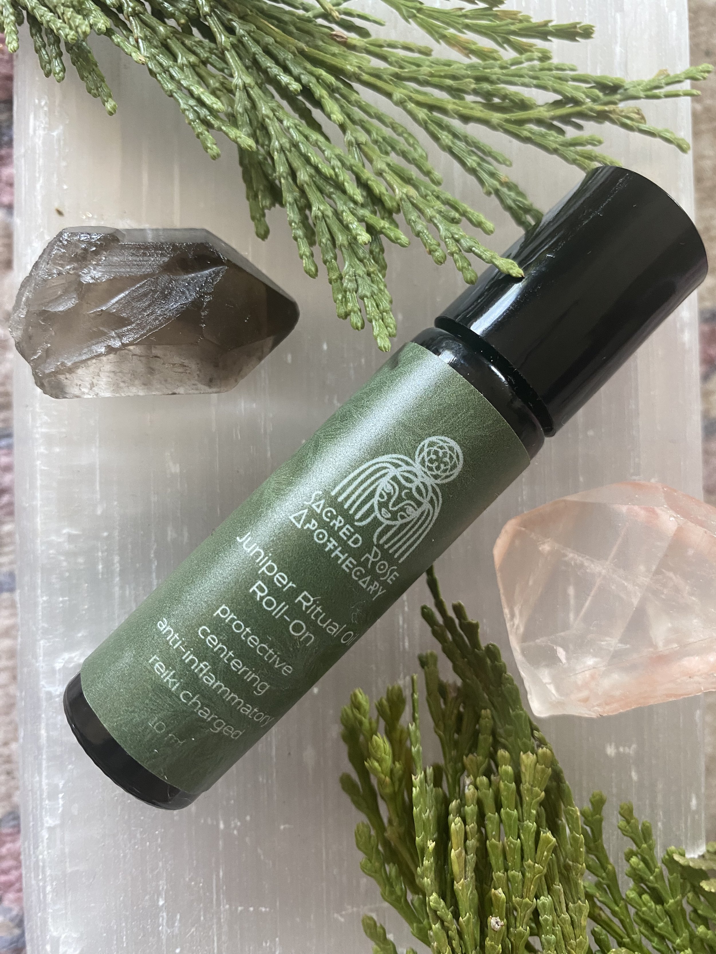 Sacred Rose Apothecary herbal infused medicinal juniper oil in a roll on for aromatherapy made by Sacred Rose Astrothecary