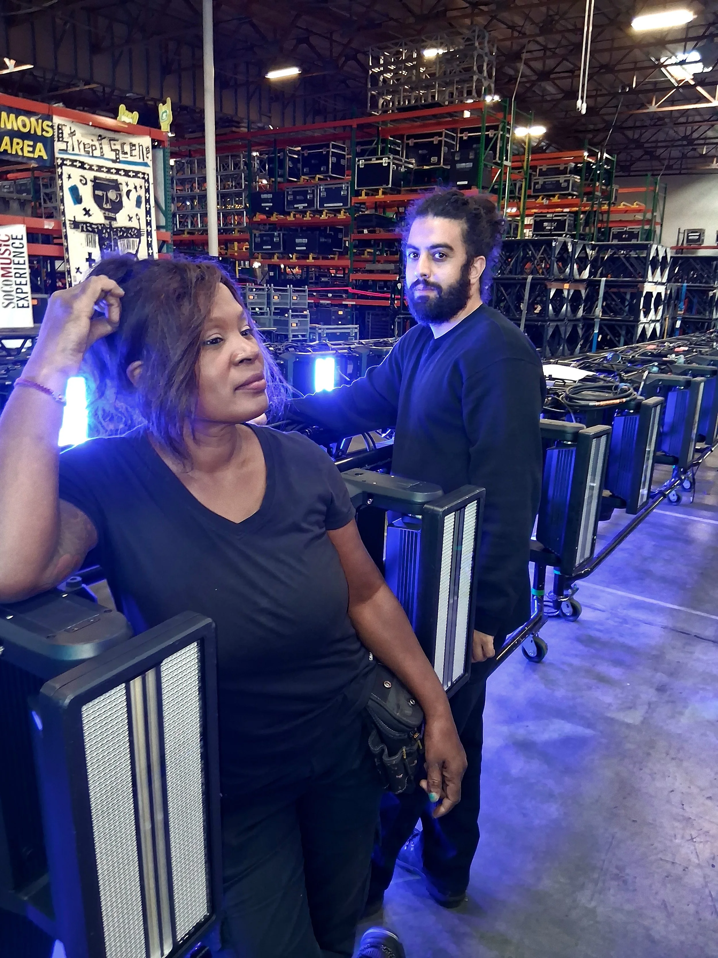 Stagehand operating high-performance Viper lighting fixtures, adjusting beams and effects on a live concert stage with dynamic lighting