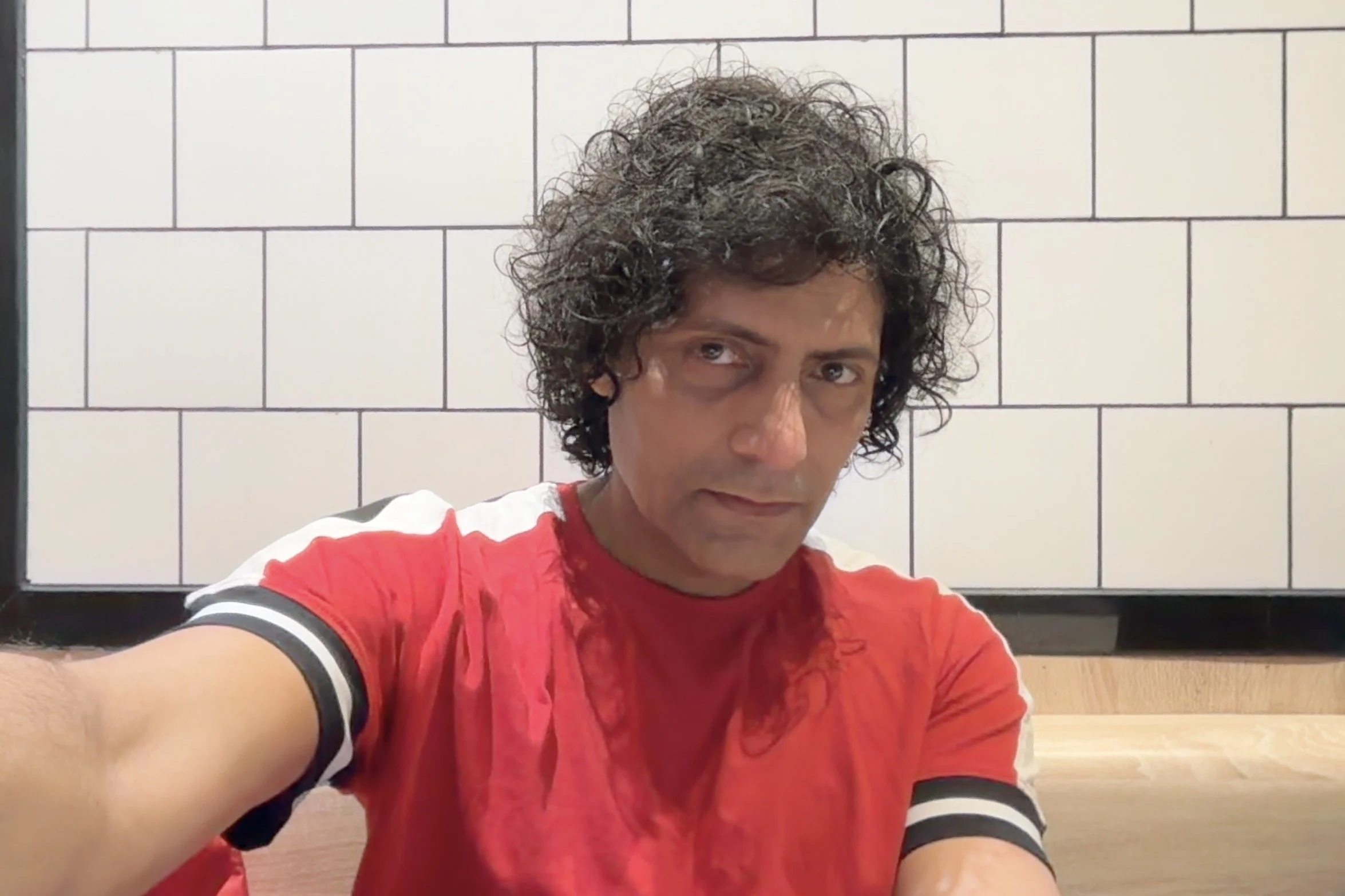 Brown man with crazy hair in a red t-shirt