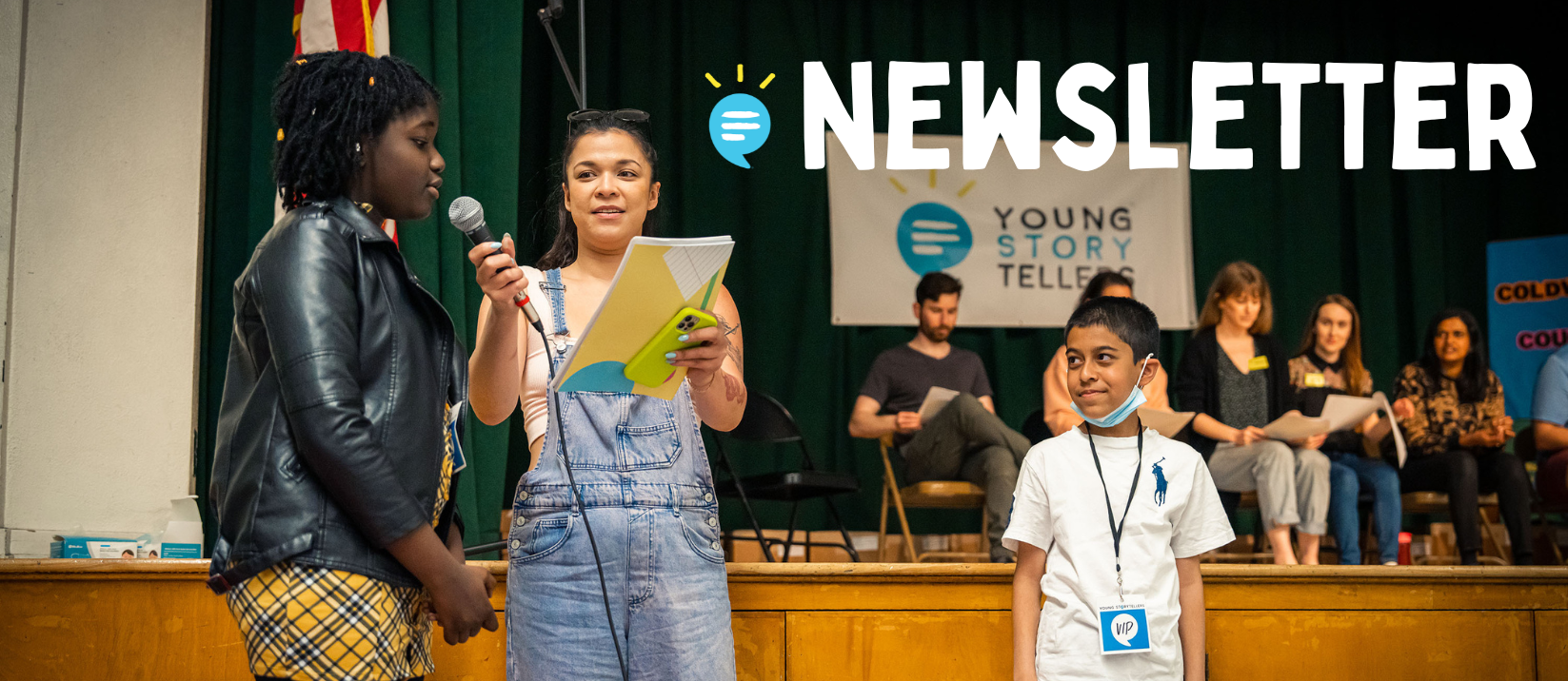 A woman in overalls holds a microphone in front of a young girl with braids and a leather jacket. A boy stands on the other side of the woman, looking at them. The word "Newsletter" is above their images.