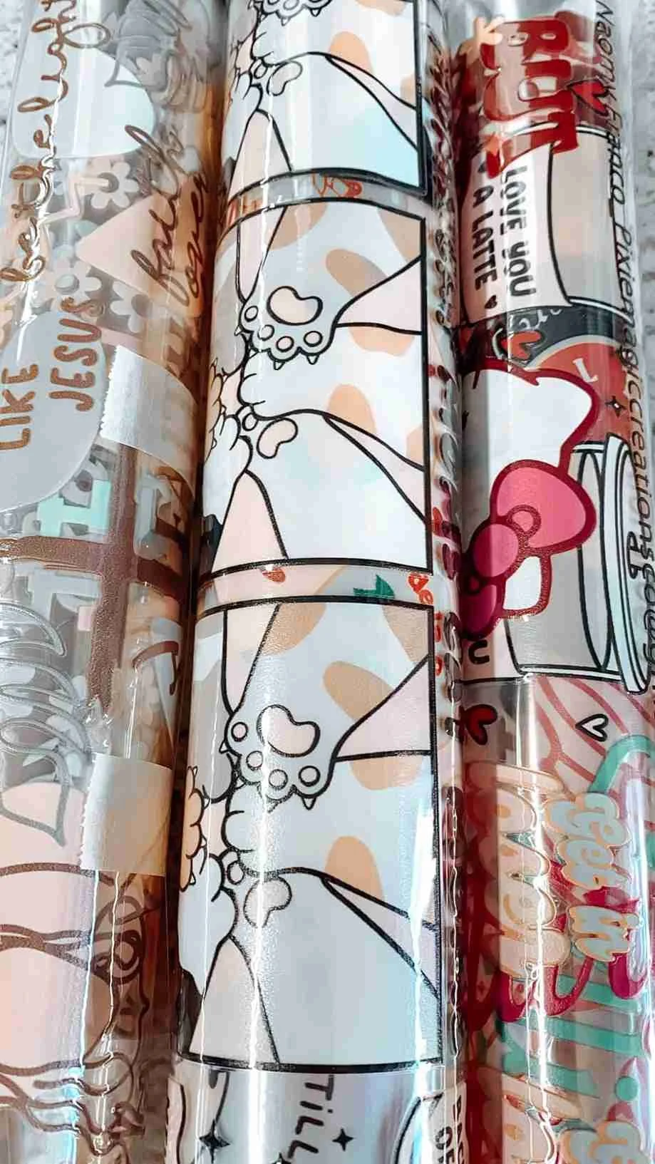 Rolls of plastic wrap with cartoon illustrations of puppies and cherries.