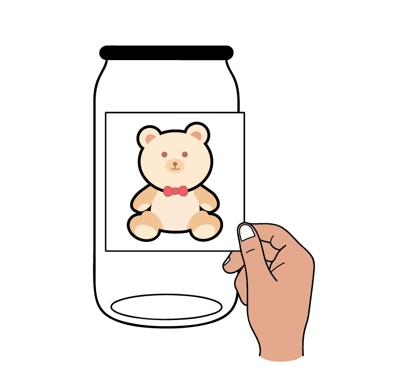 A hand holding a square picture of a cute teddy bear with a red bowtie, set against a black background.