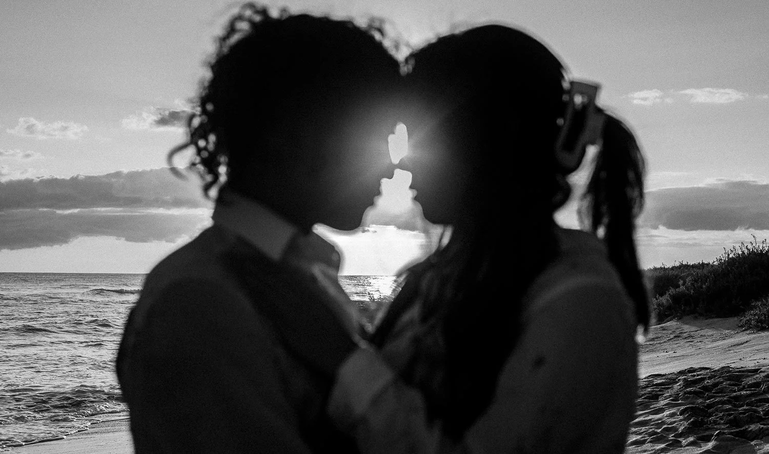 Ken and Mai nose to nose on a Hawaii beach.
