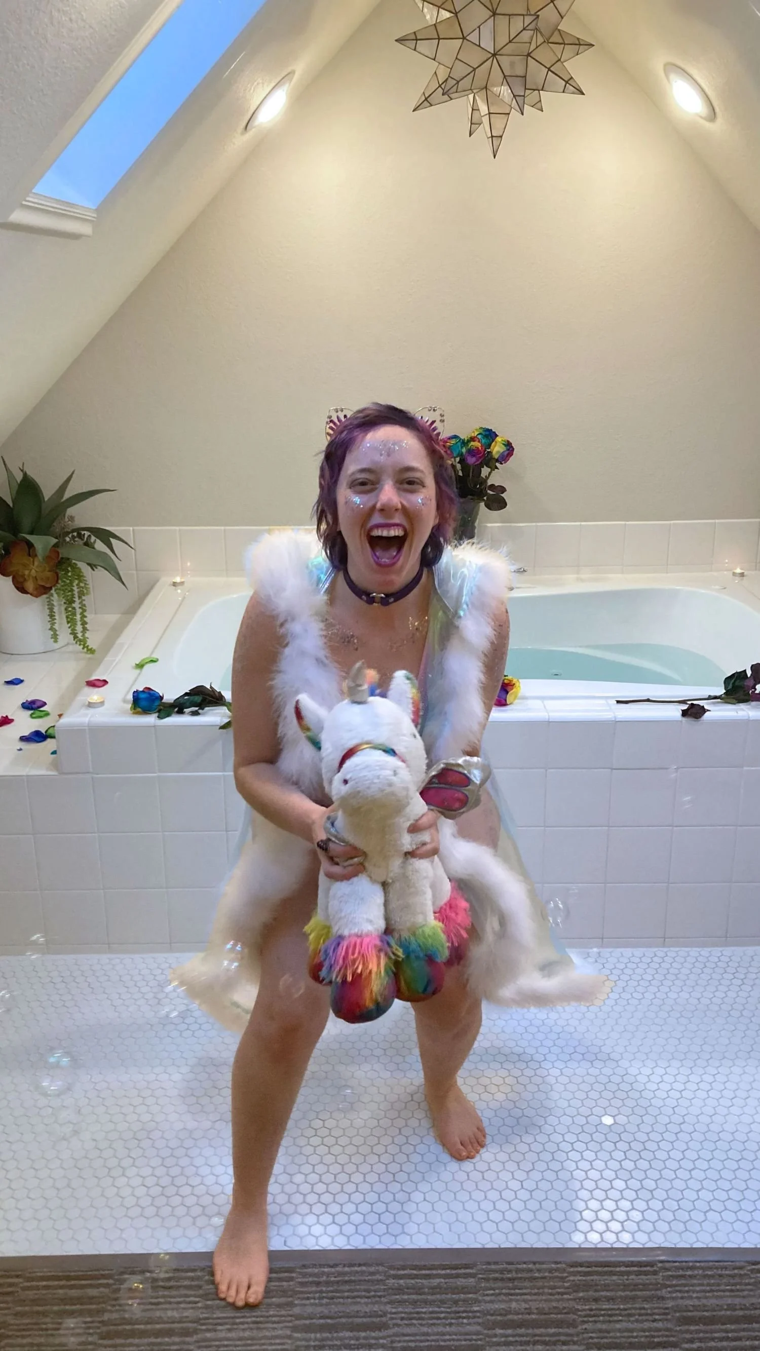 Michaela Rose Soleil on a unicorn laughing with bubbles around her